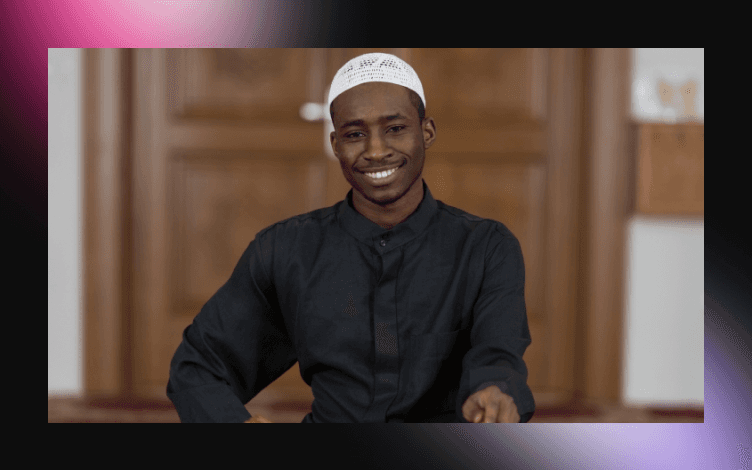 Cheerful young man wearing a prayer cap with a warm smile, conveying a positive and spiritual demeanor on the day of Jummah.