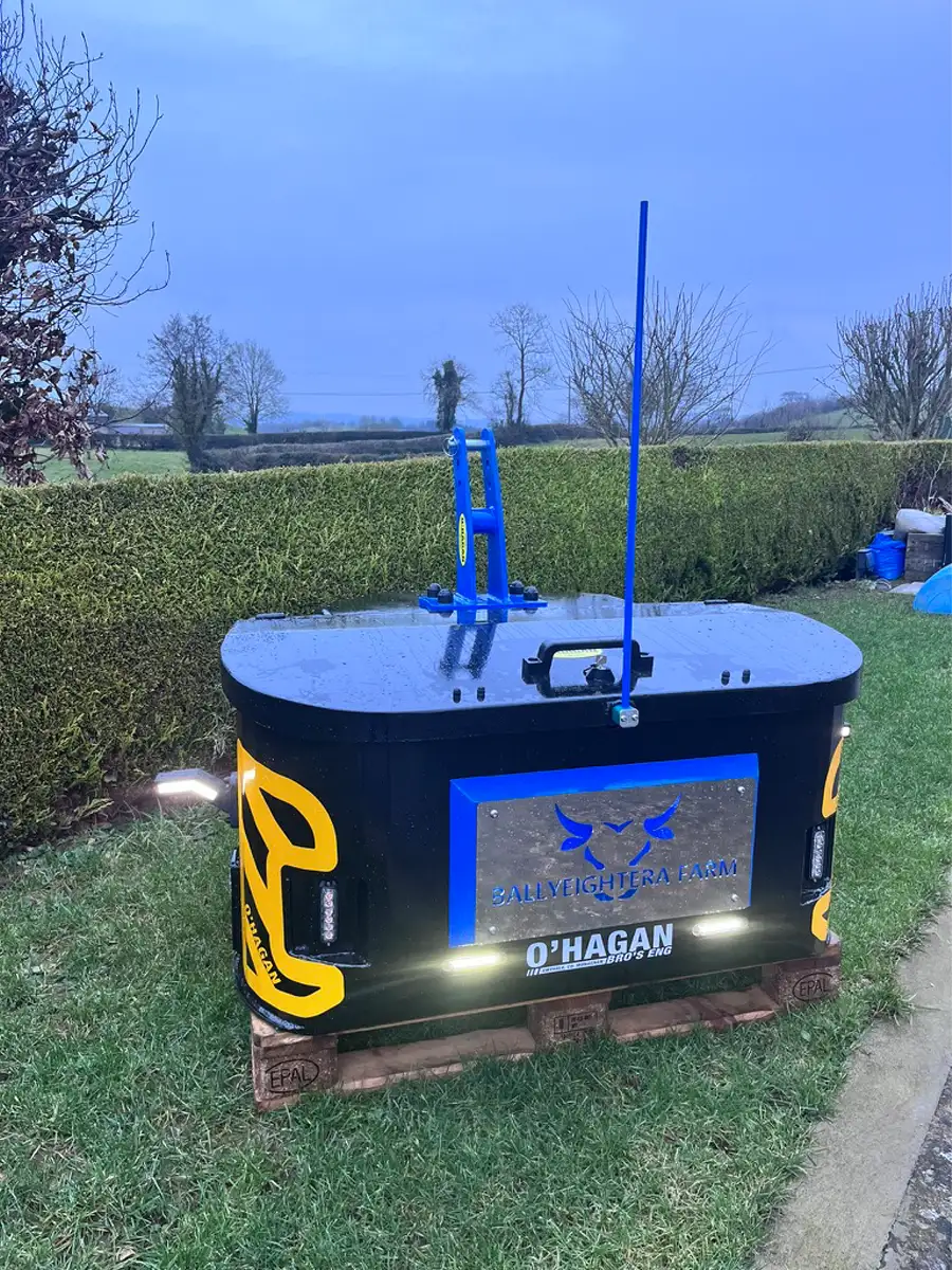 Black and blue work box with custom name plate sitting on a wooden pallet on top of grass