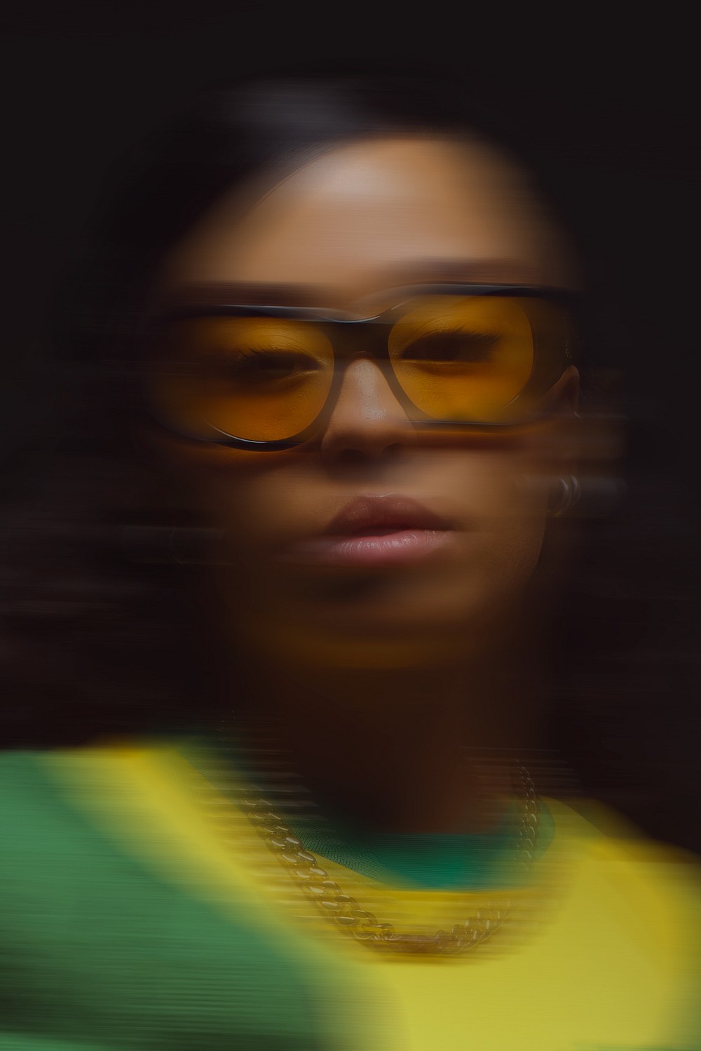 Tree branches against white house and fence
