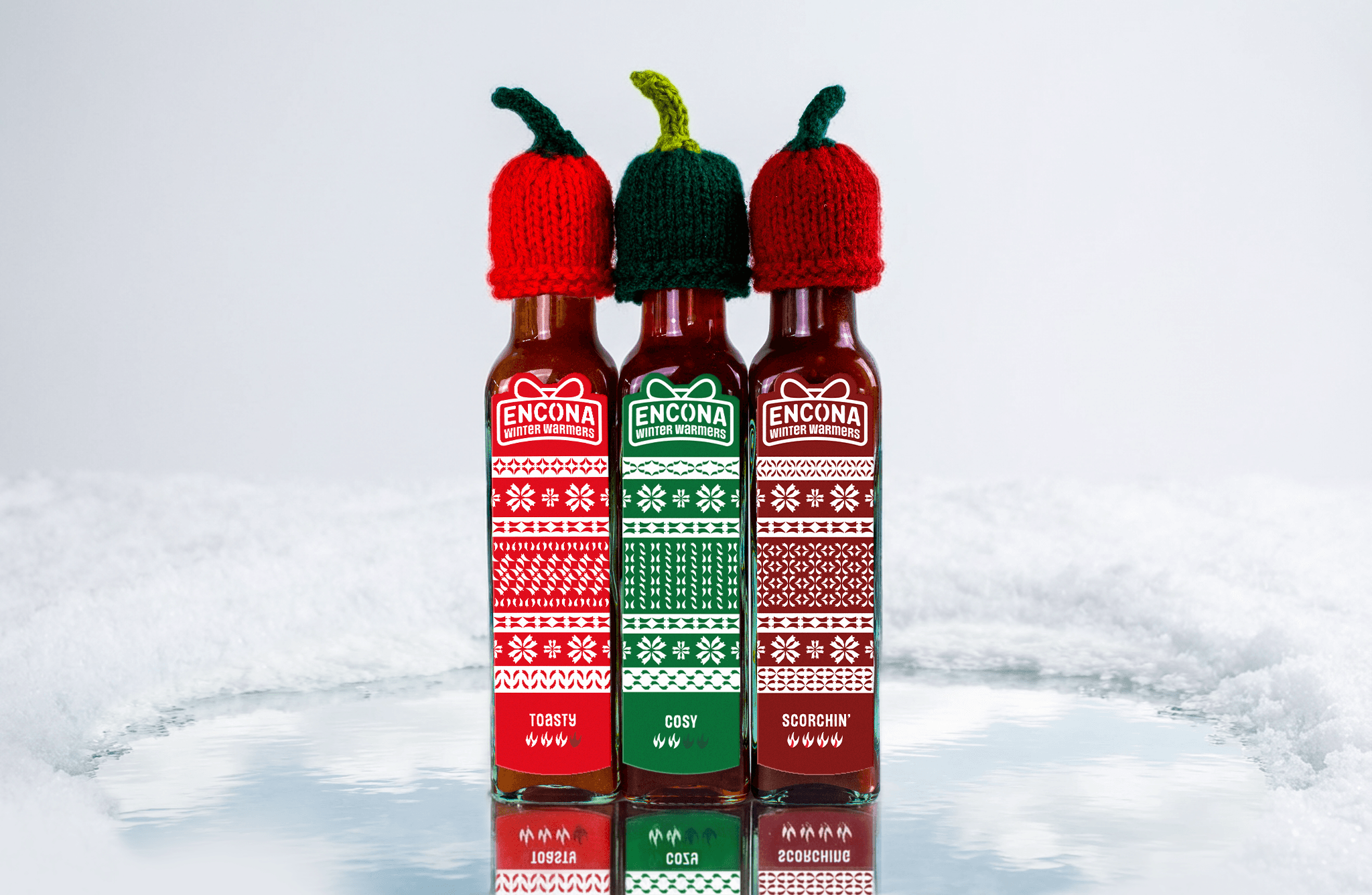 Christmas hot sauces sat in the snowy winter backdrop