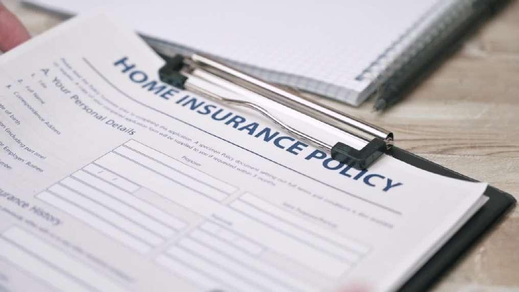 A home insurance policy form on a clipboard