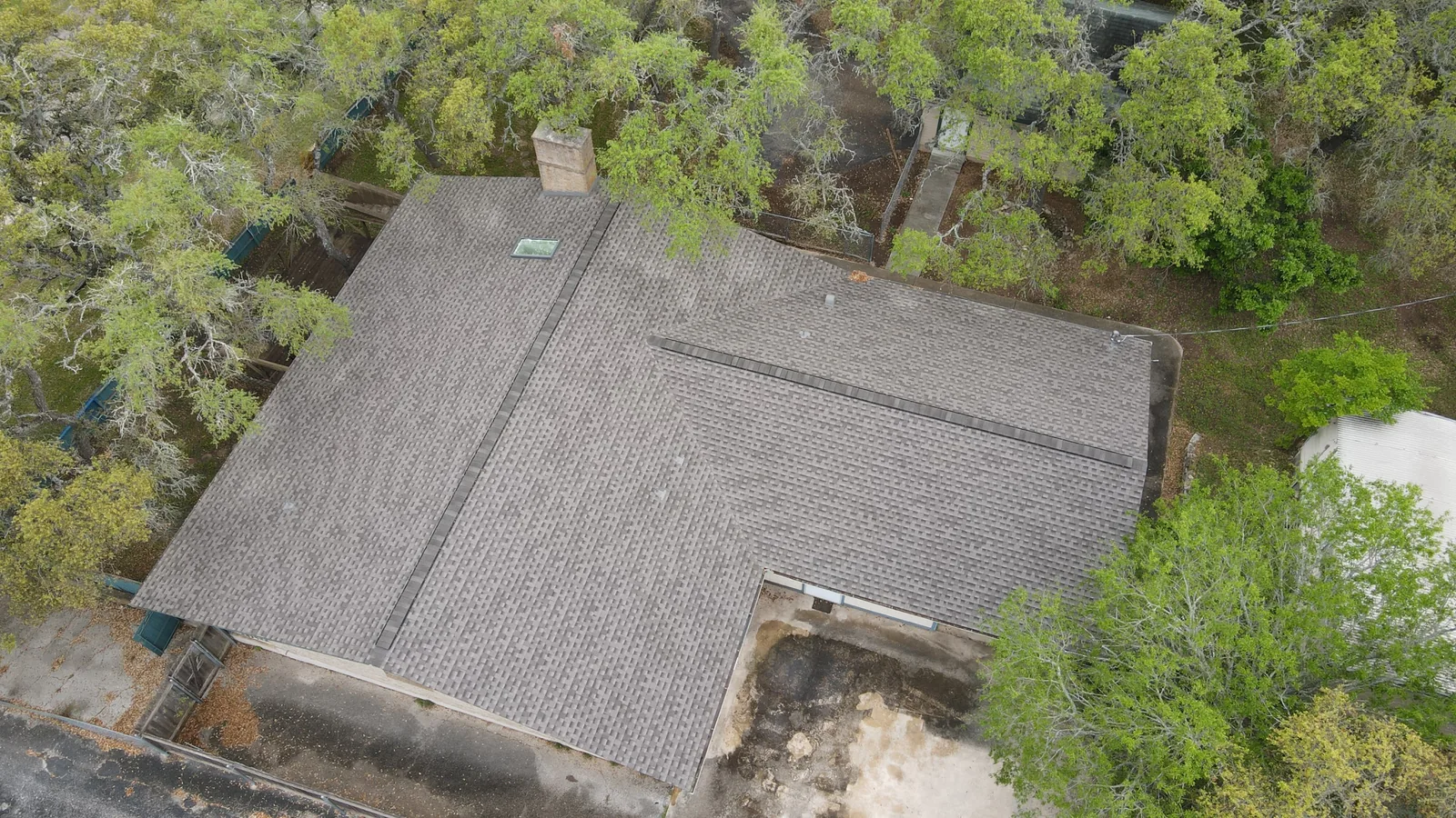 After - another angle: gray shingles around a skylight.