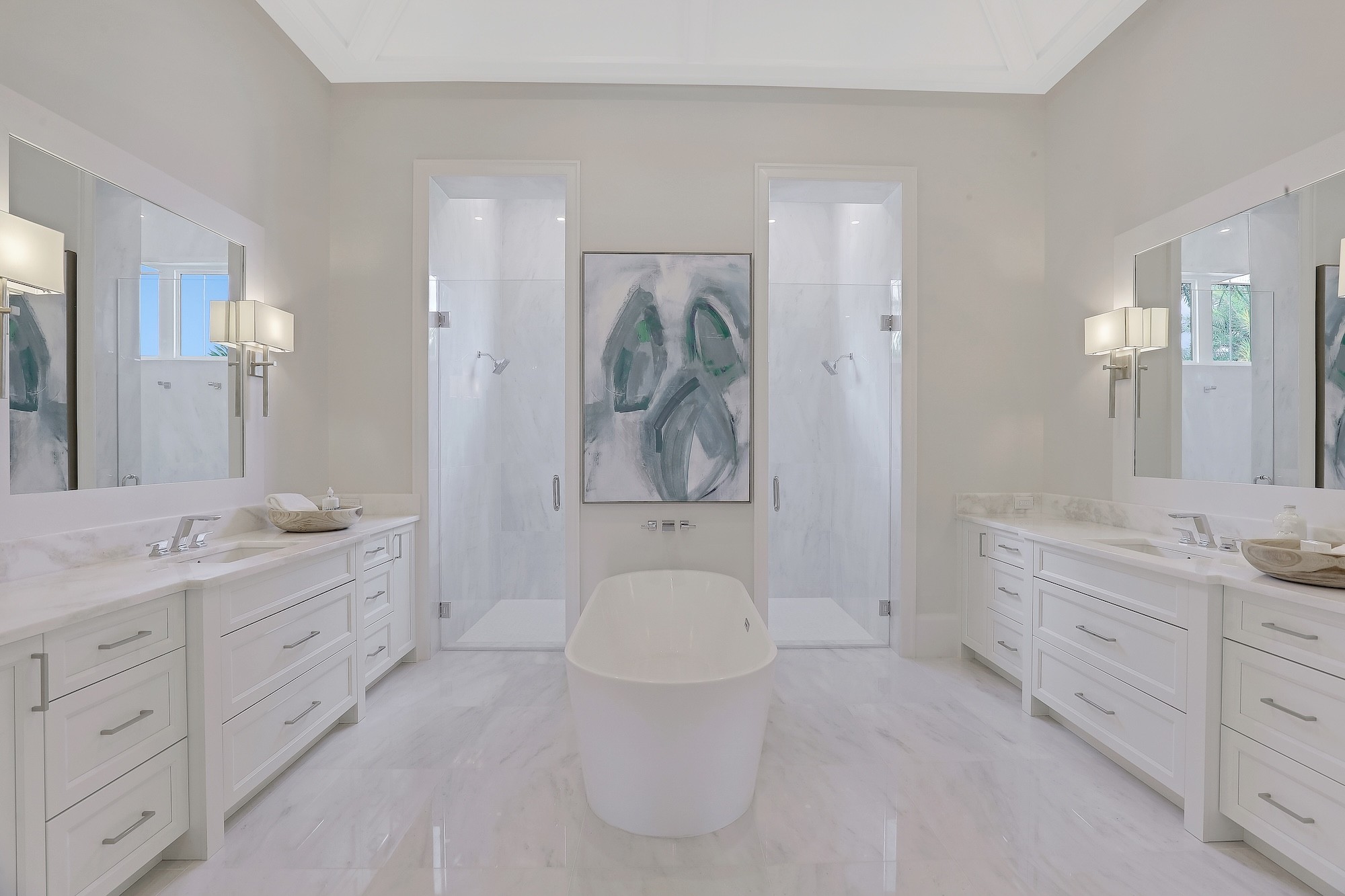 a large modern bathroom with marble floors and white cabinets