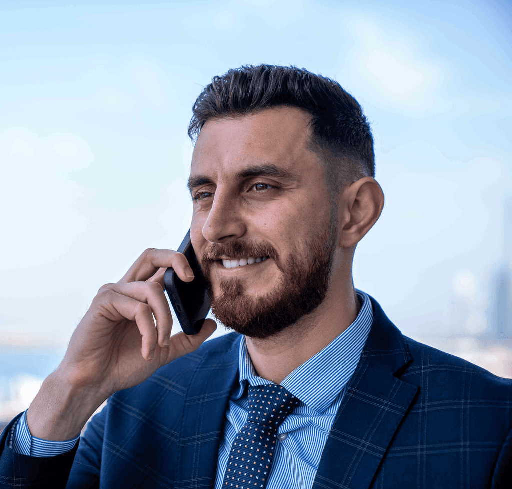 Businessman on phone outdoors, showcasing remote communication supported by virtual offices abu dhabi setup.
