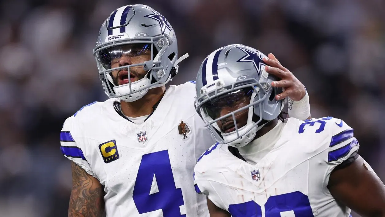Dallas Cowboys players celebrating on the field during an NFL game at AT&T Stadium.