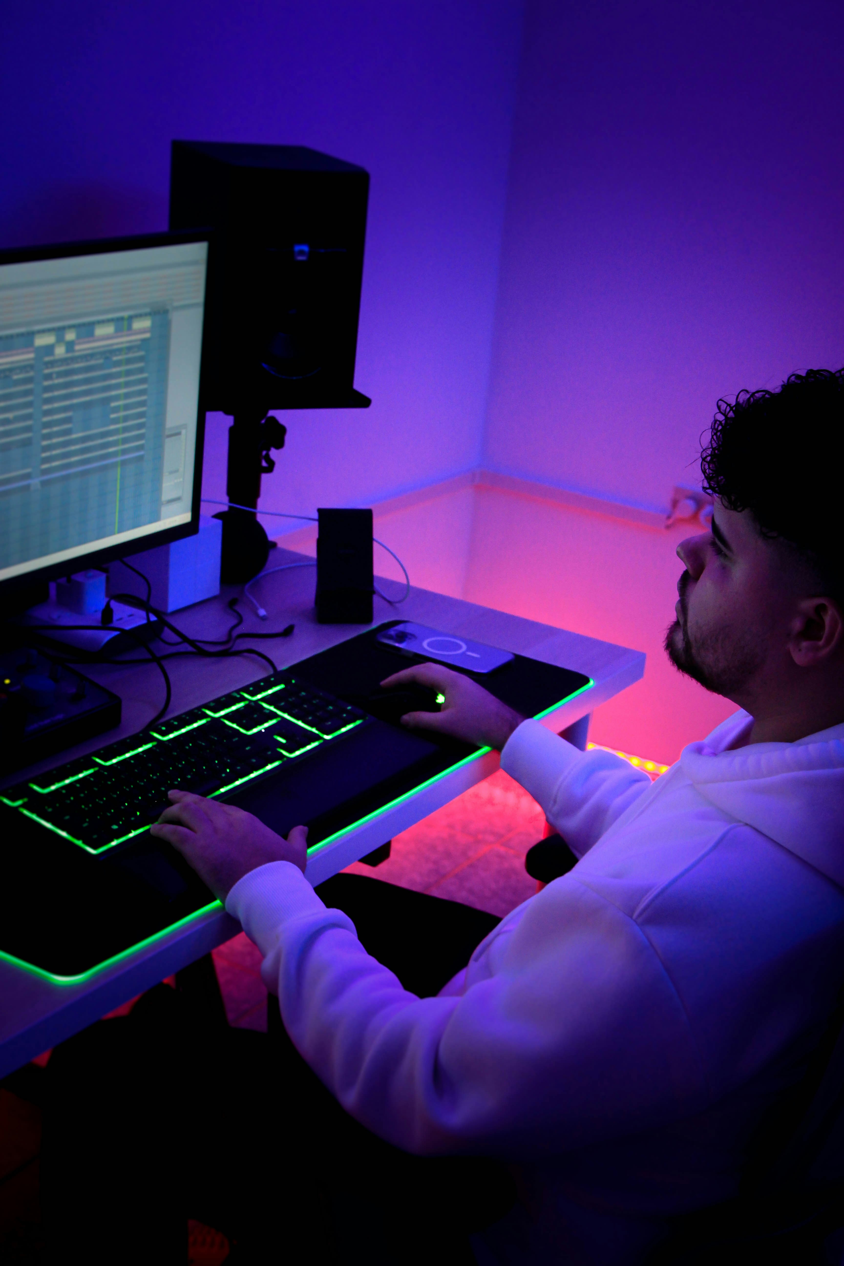 guy working on computer desk with neon led lights