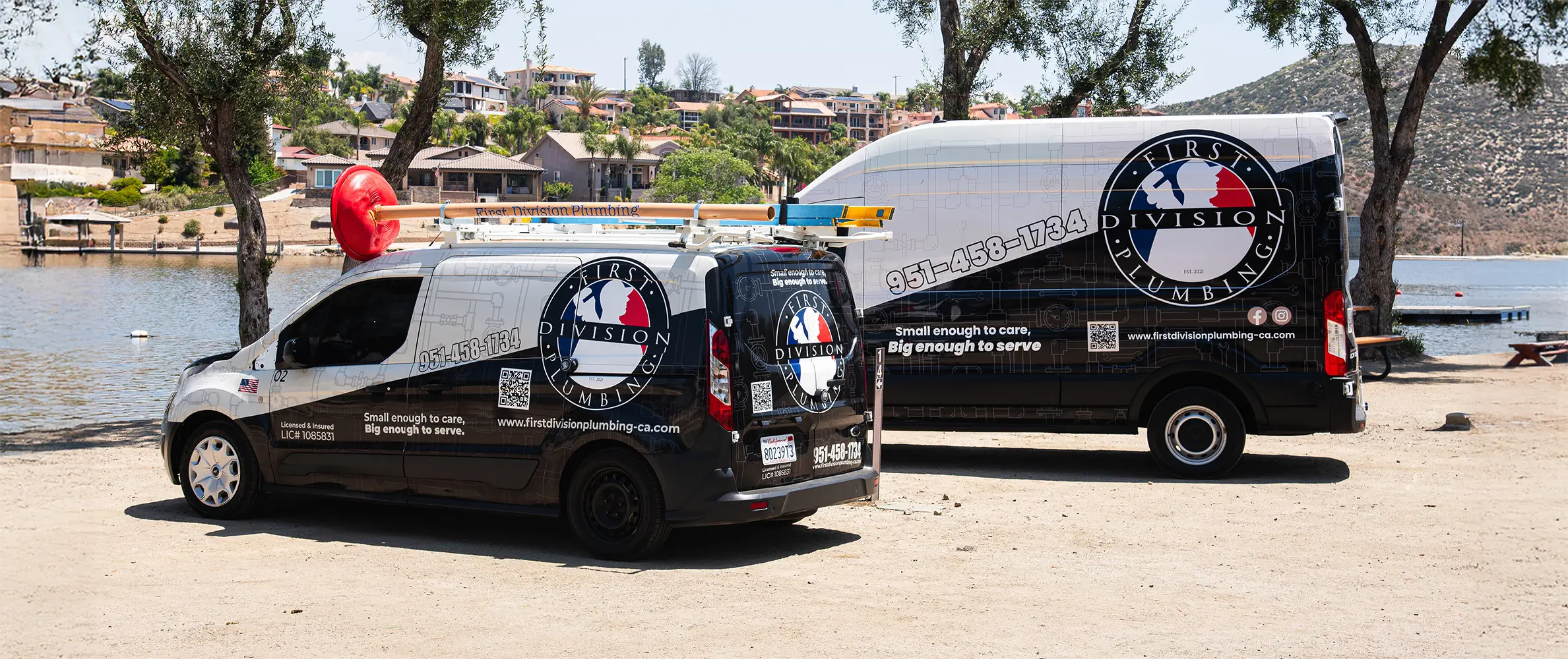 First Division Plumbing service vans parked near Lake Elsinore, showcasing branding and readiness to serve Southwest Riverside County.