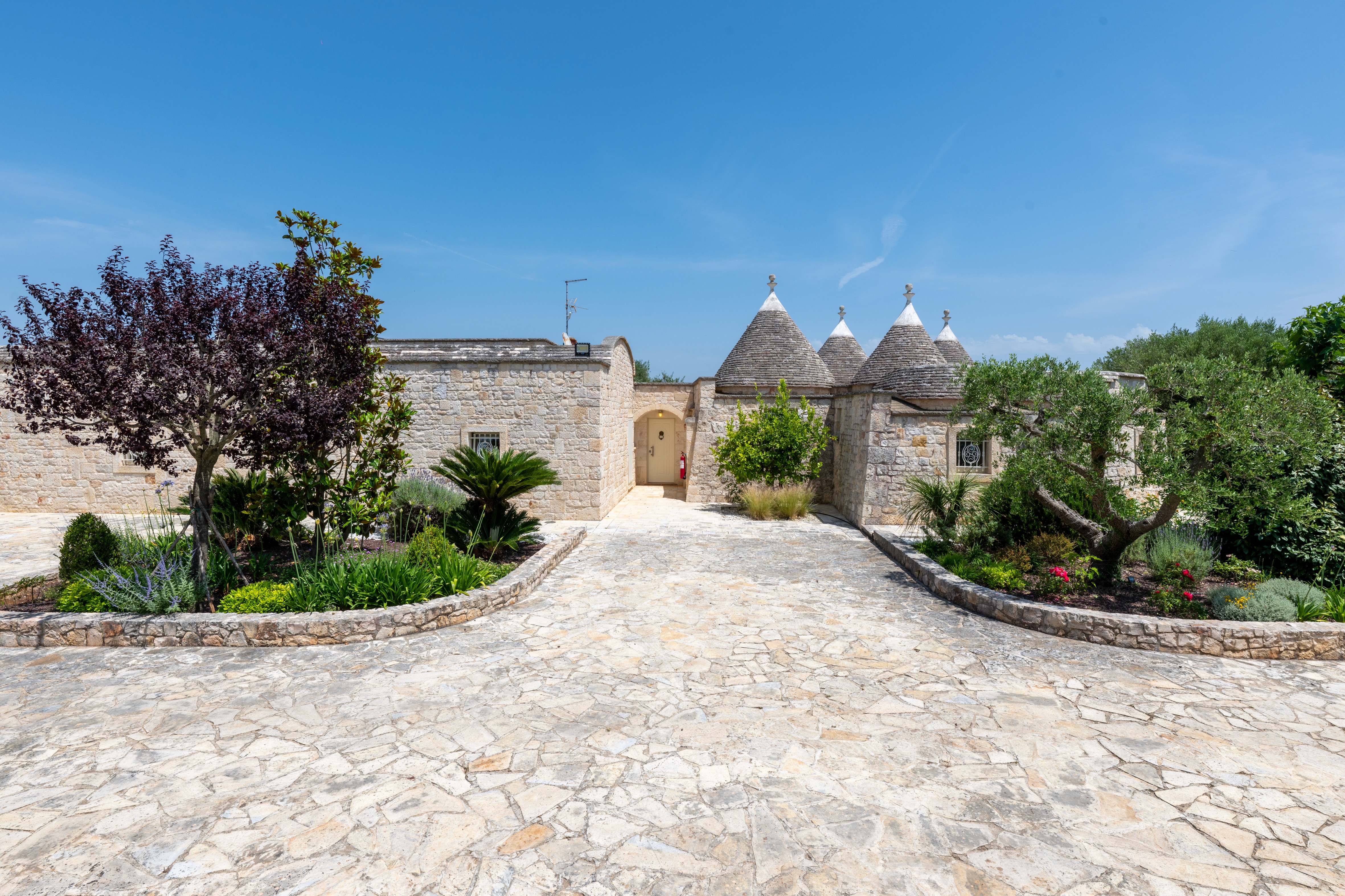 Modern hillside house with stilts and glass railing
