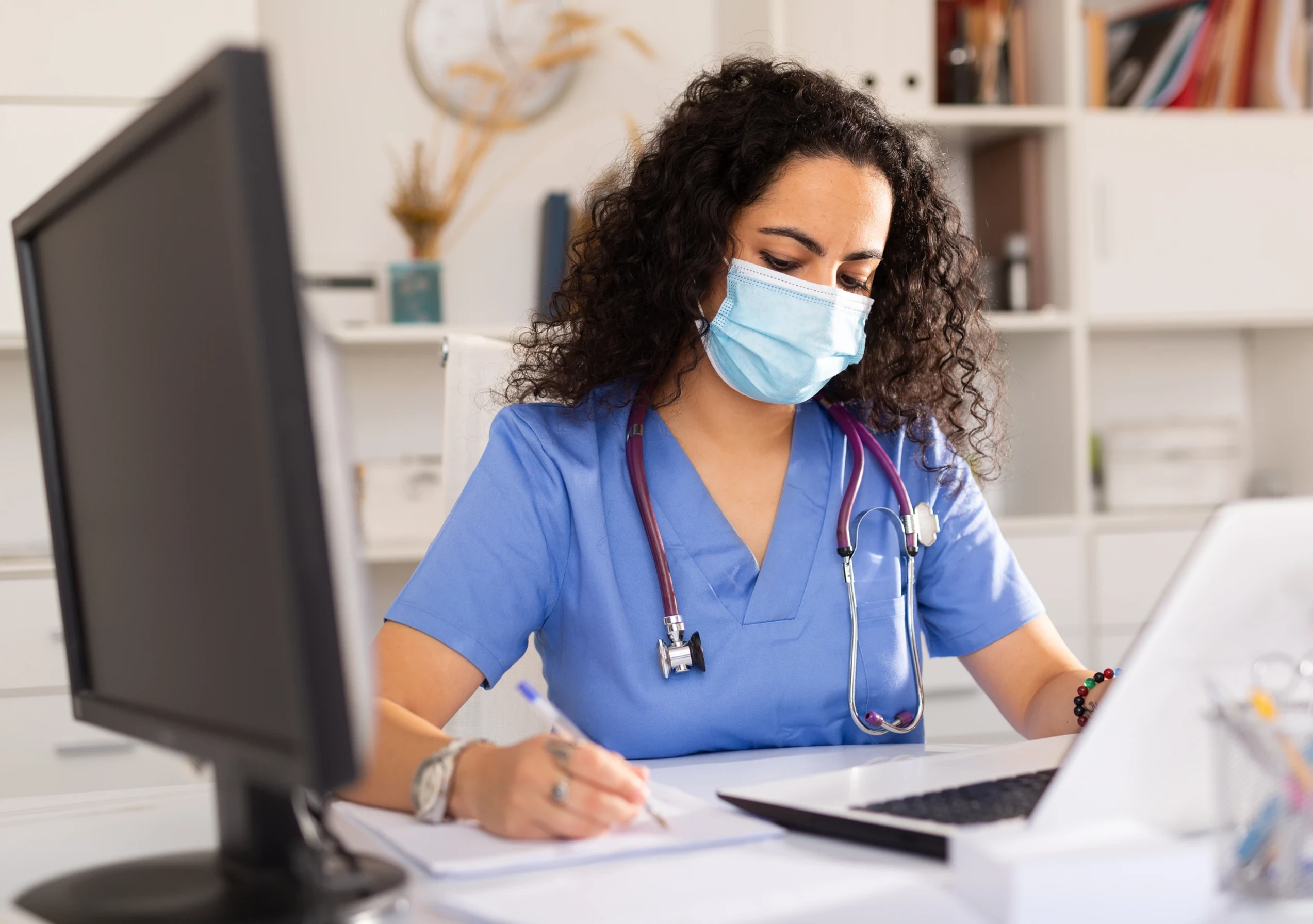 Nurse checking her work computer.