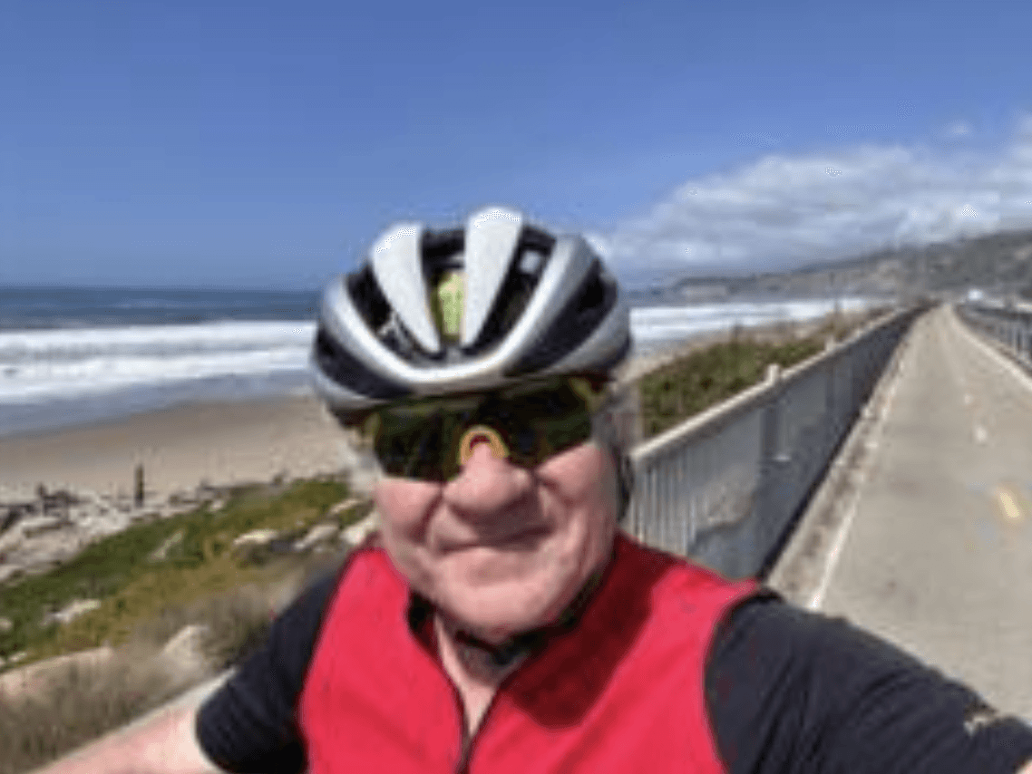 a woman with long brown hair smiling at the camera
