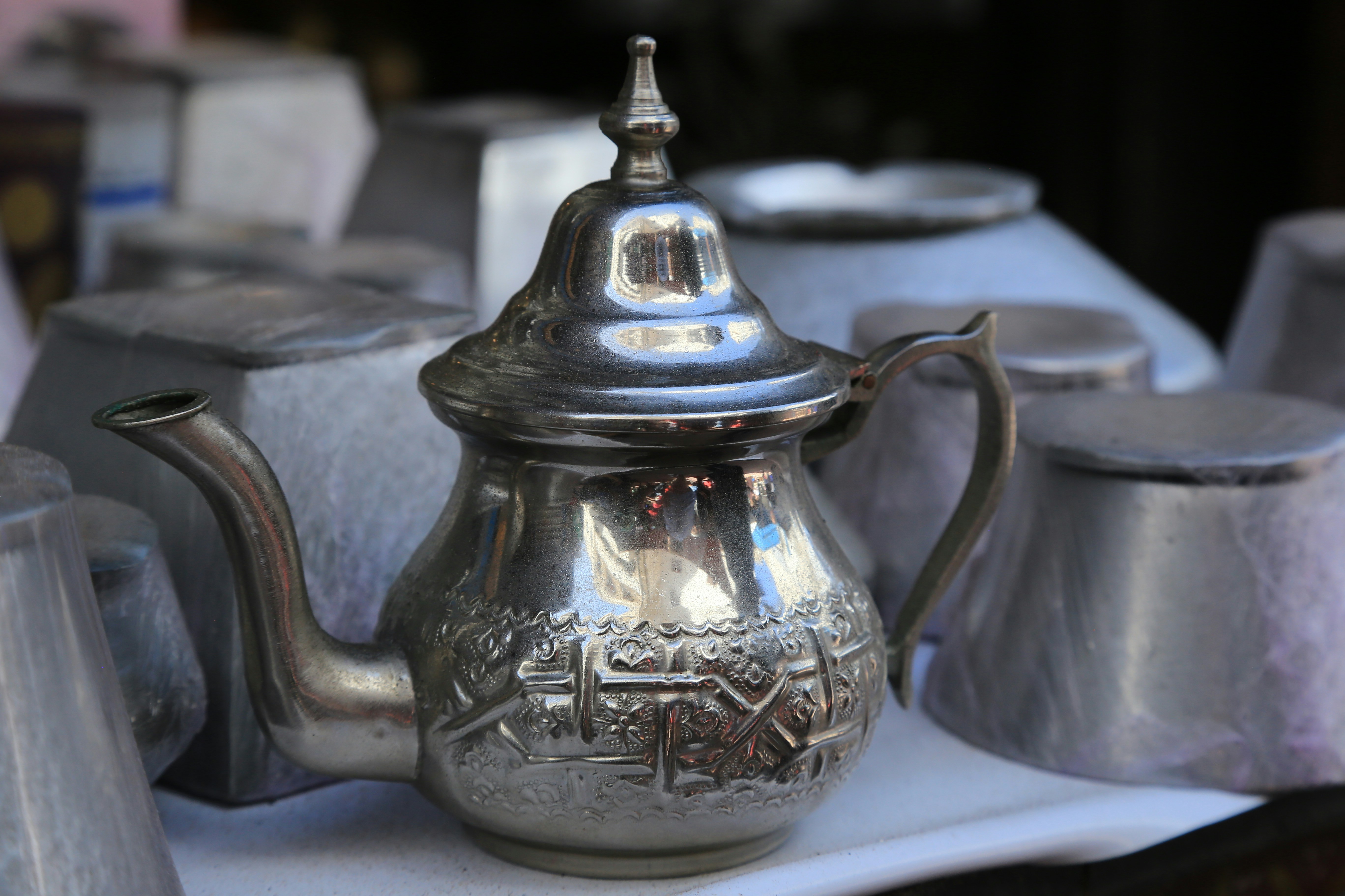 a silver tea pot sitting on top of a table