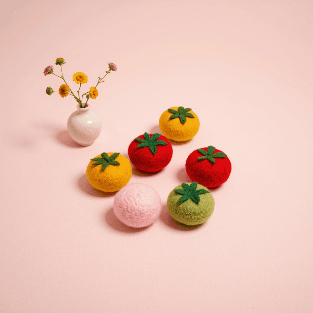 product photography of felt tomato shapes
