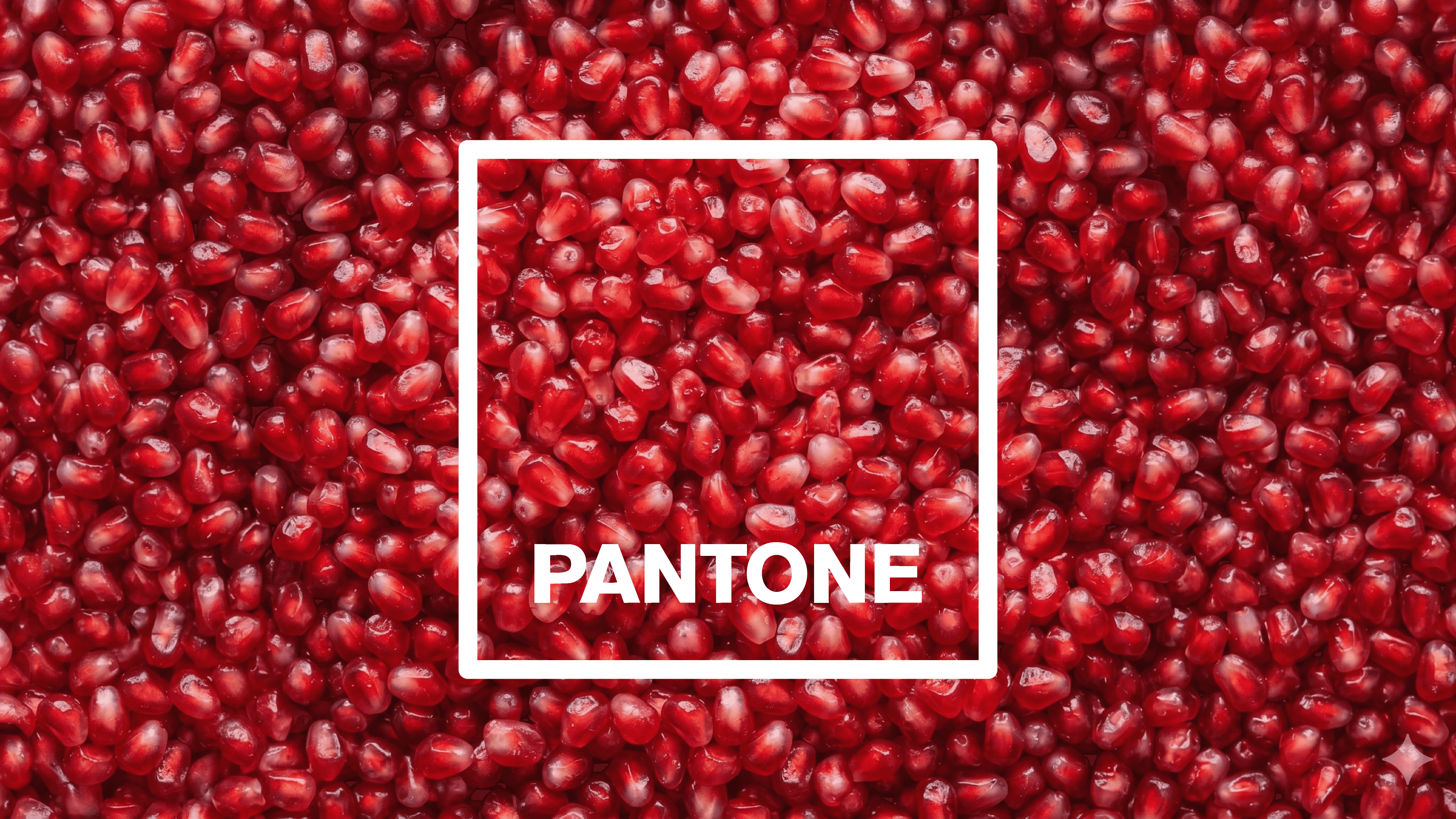 Pantone logo framed over a close-up texture of red pomegranate seeds.