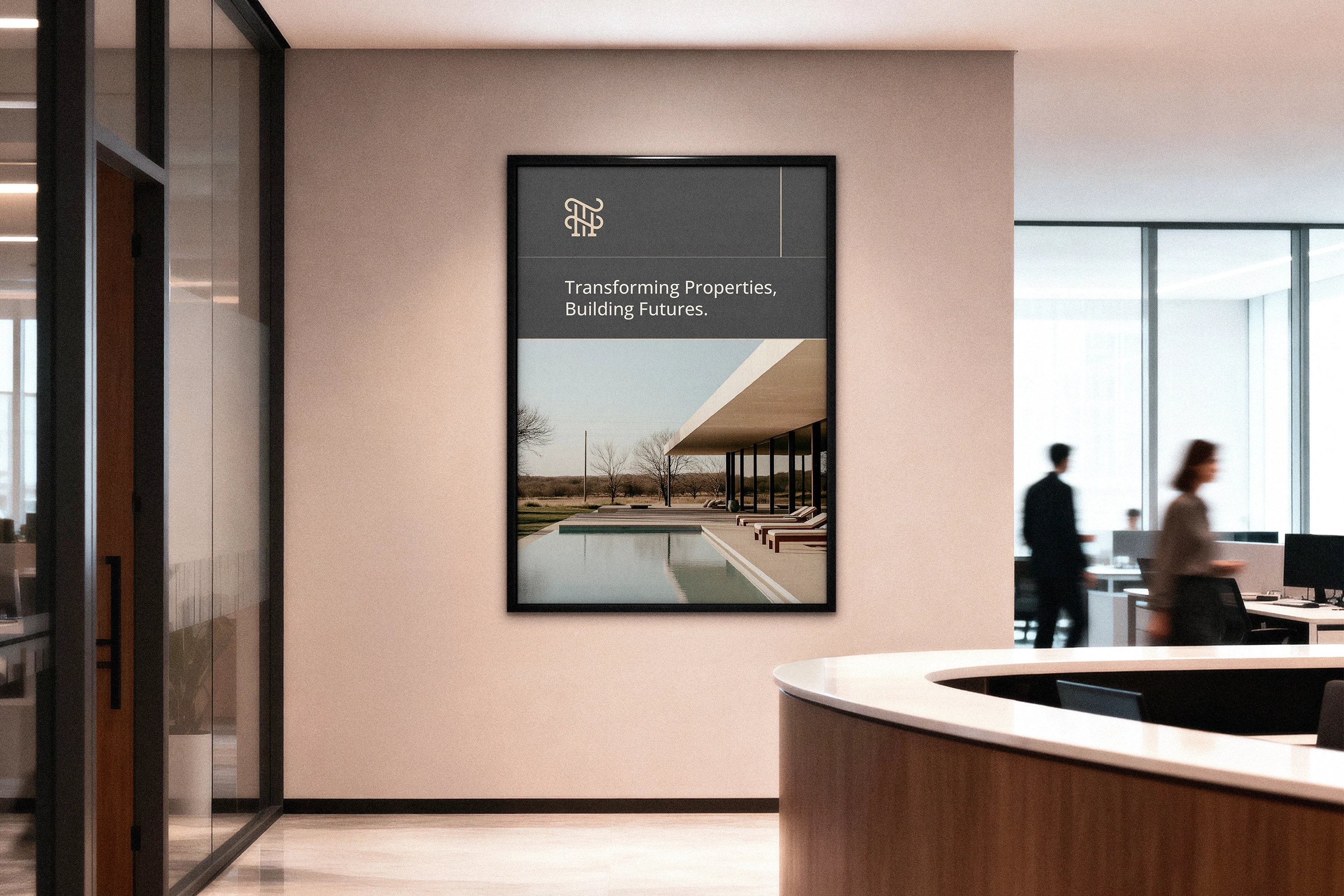 A modern office interior features a framed architectural poster on the wall with the tagline "Transforming Properties, Building Futures," depicting a sleek, contemporary building with large windows overlooking a serene landscape.