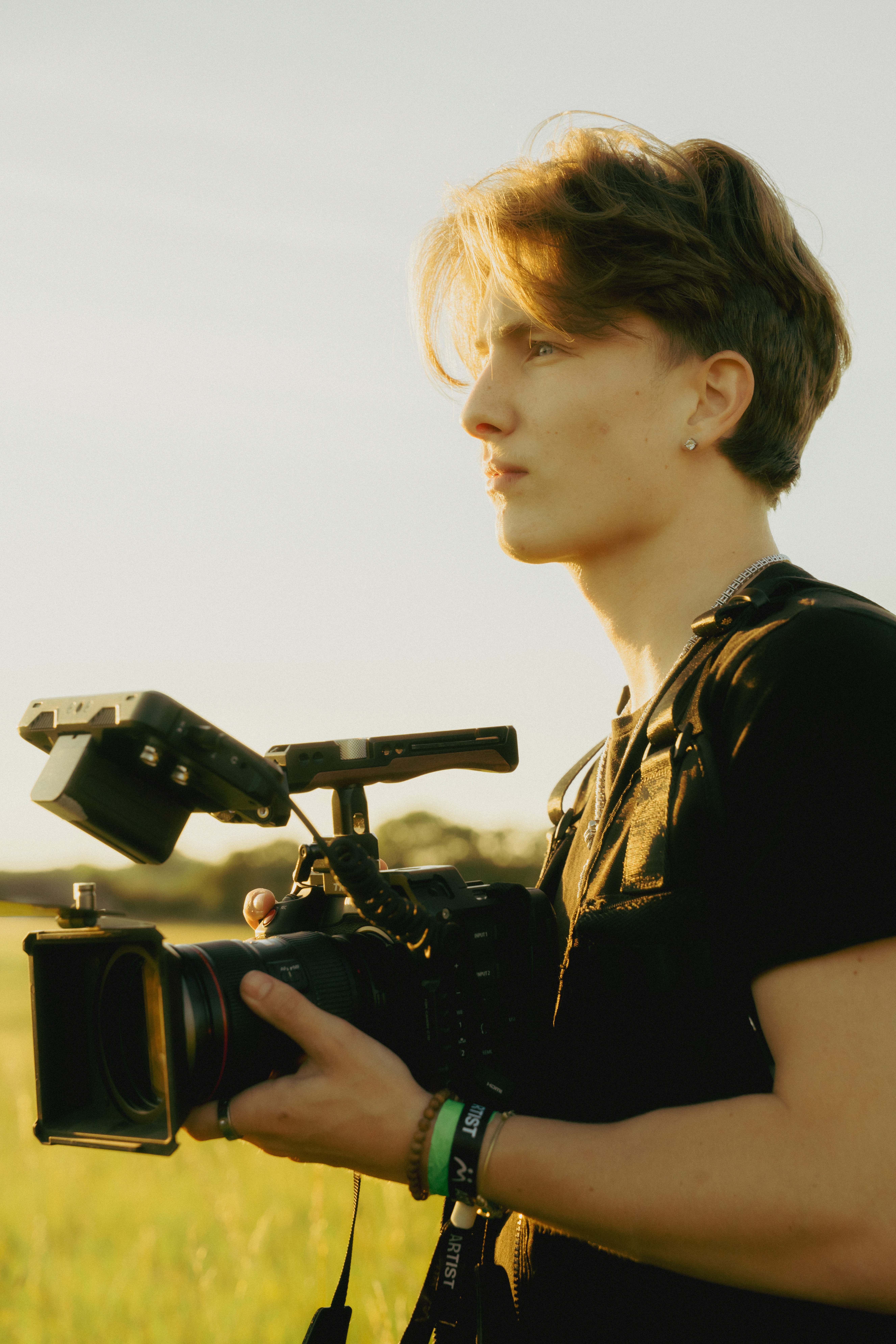 Three people sitting on a couch in a room looking at mobile devices