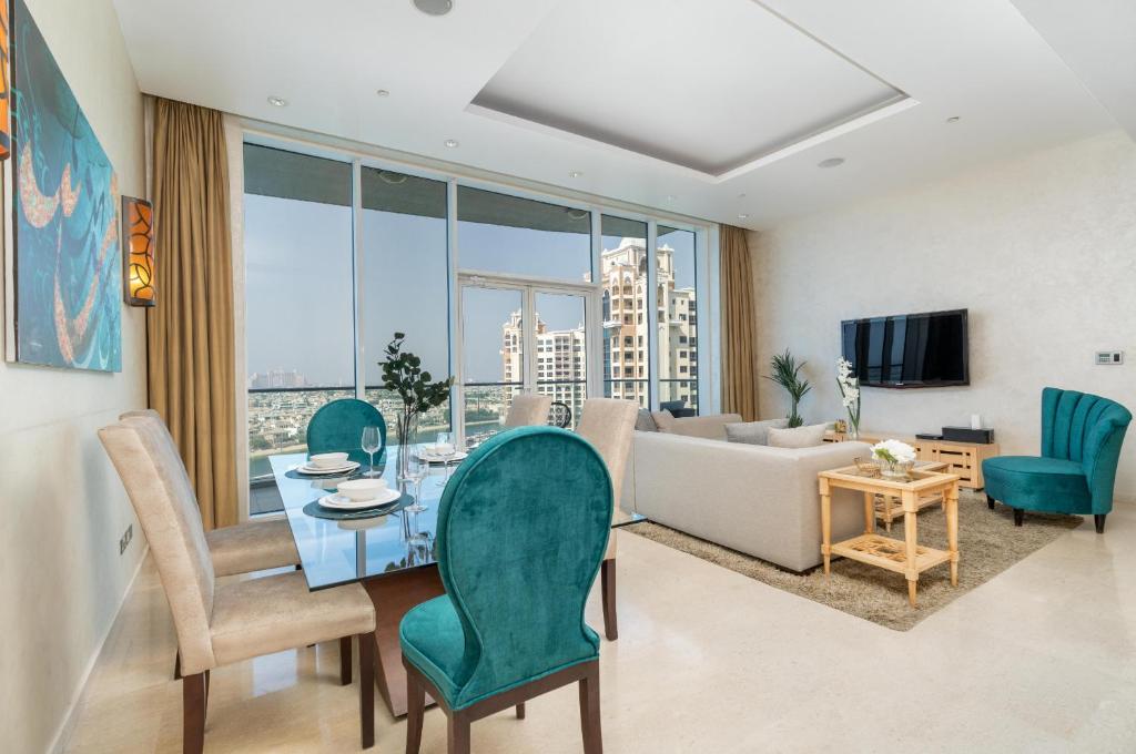 A living room featuring a dining table with chairs, showcasing the elegant design of Oceana Residences.