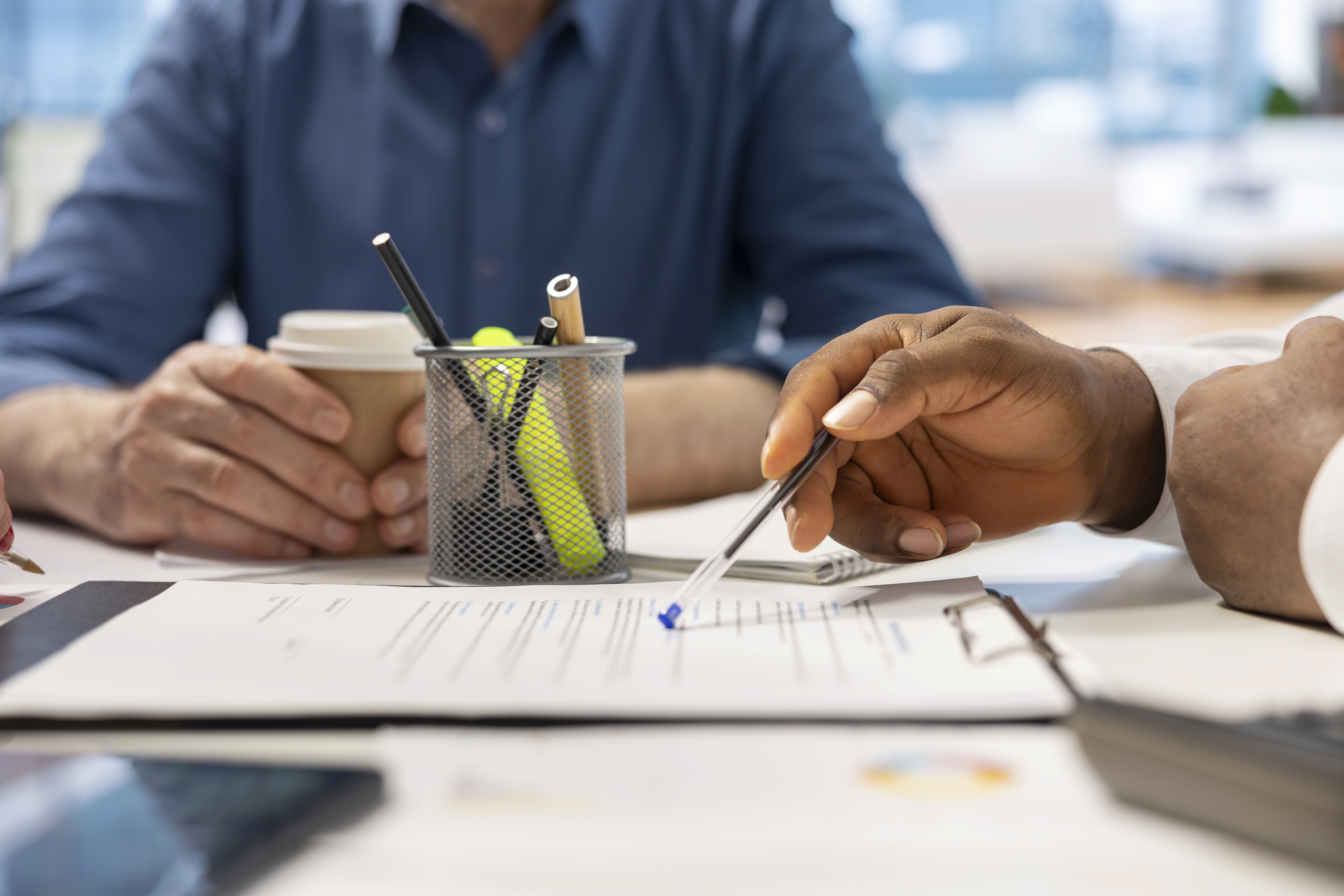 man wearing gray polo shirt beside dry-erase board
