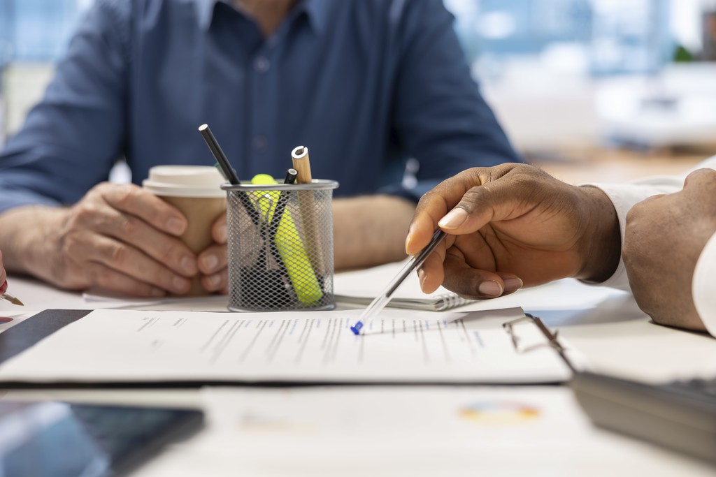 man wearing gray polo shirt beside dry-erase board
