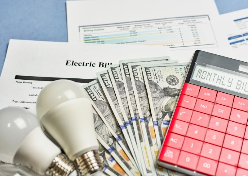 bulbs and calculator on 100 dollars bills