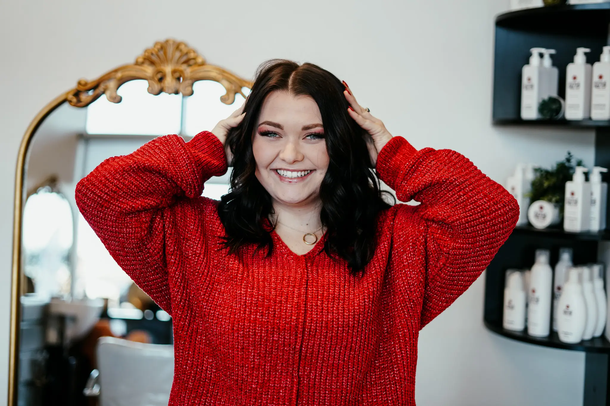 An image of Tasha Smith, owner of Style Me Up, sitting in a salon chair.