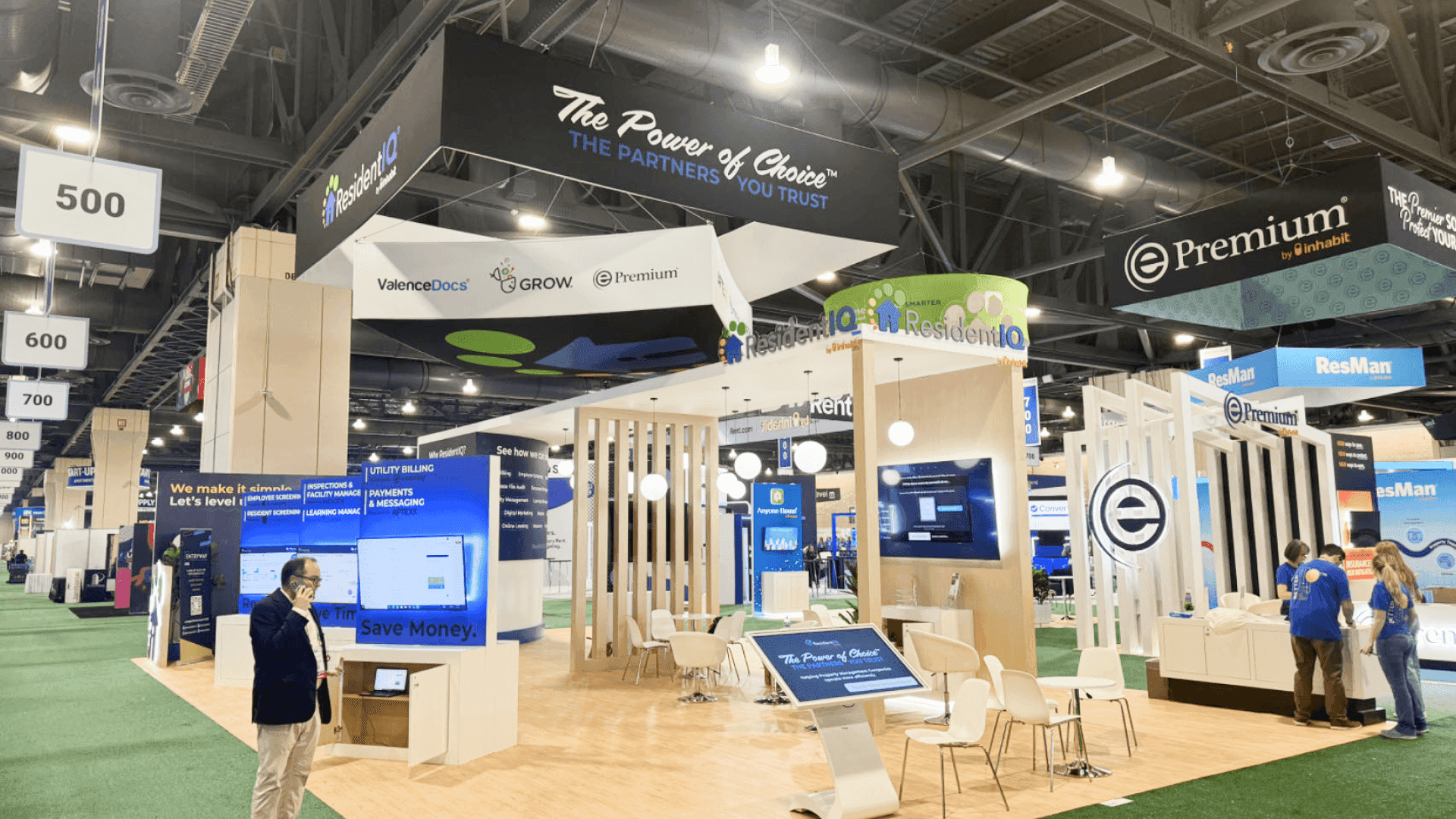 20x20 titanium industry booth at Caesars Palace Las Vegas prepared with alloy sample displays, technical graphics, and executive meeting area