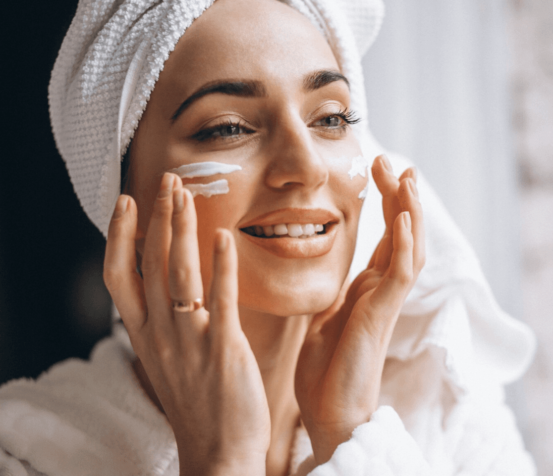 woman applying skincare cream on face