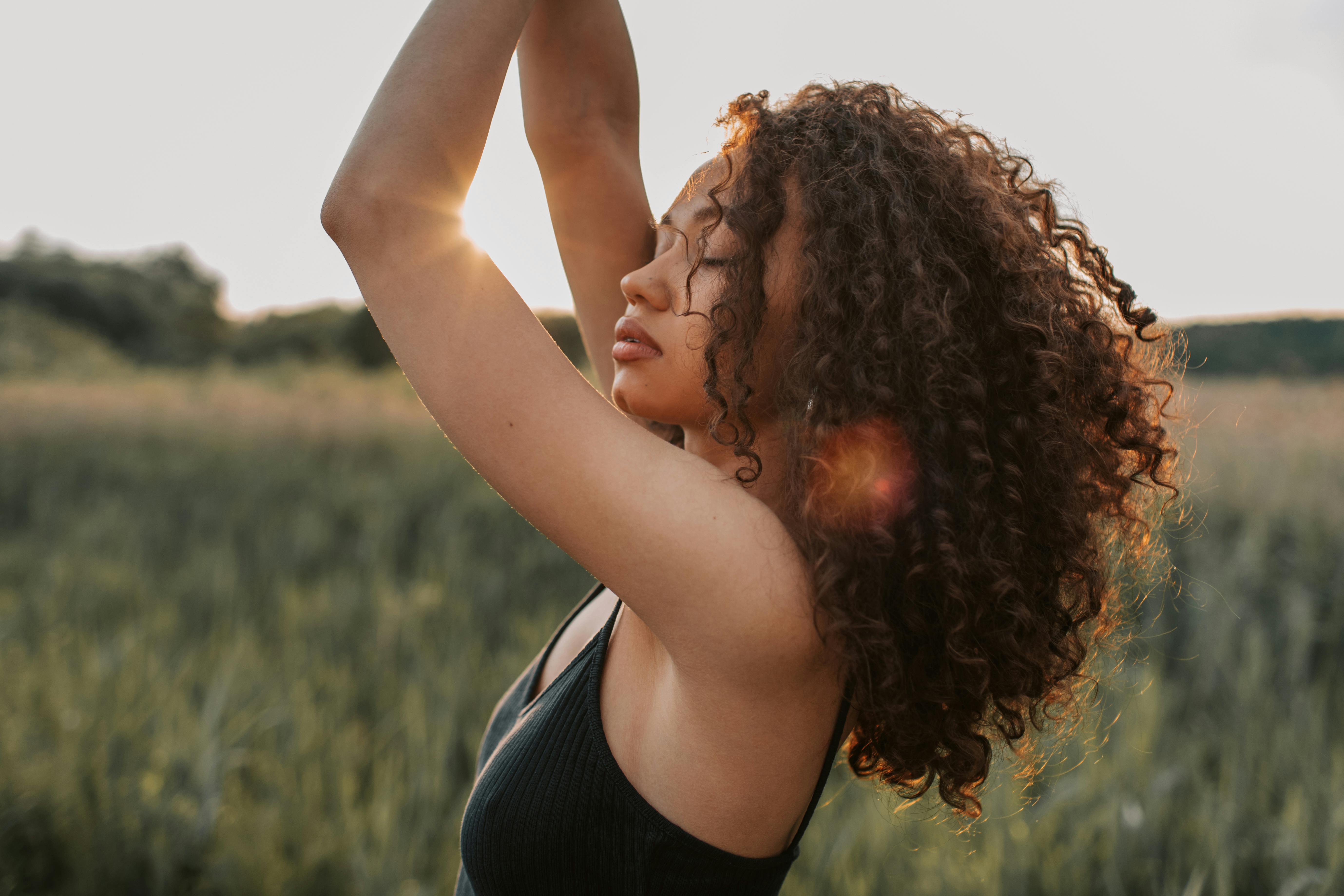 A feminine and sensual woman standing in a field