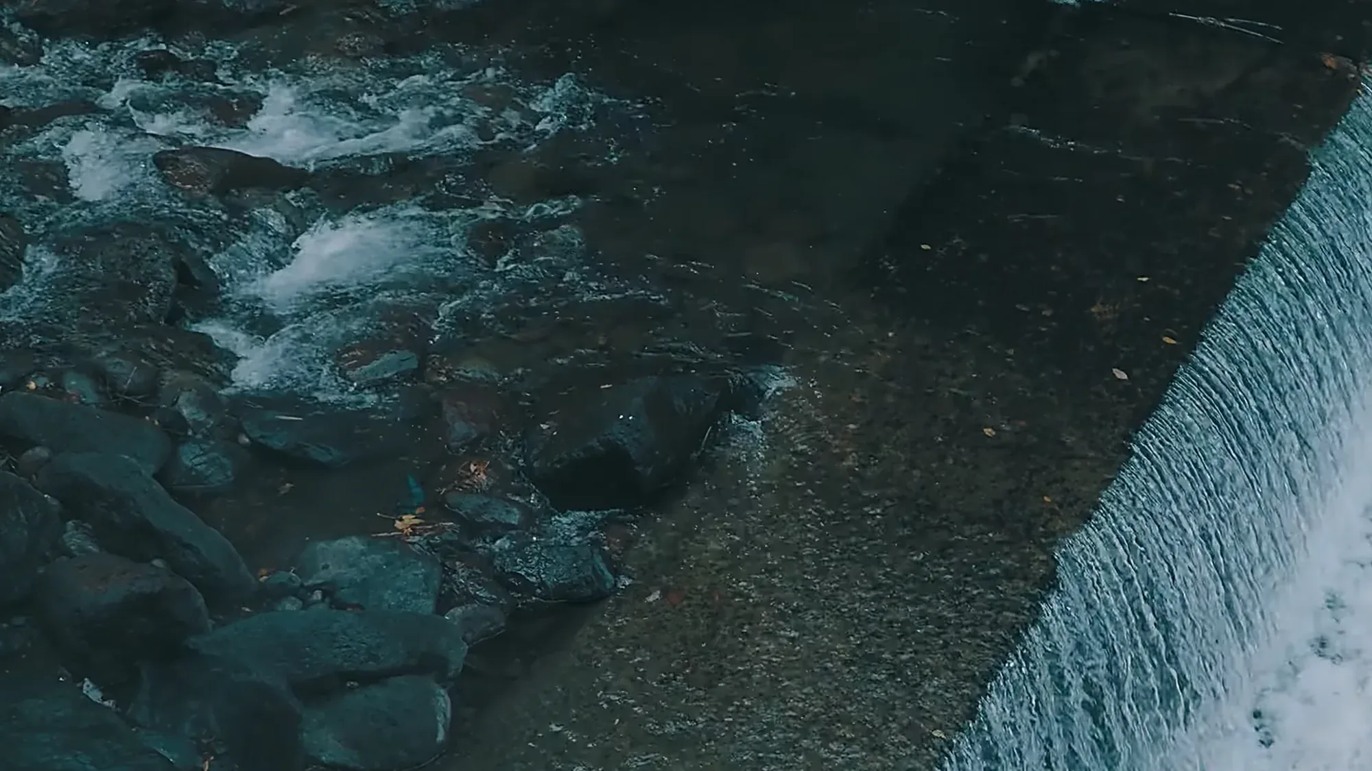 White water running over a river weir near Kurokawa Onsen