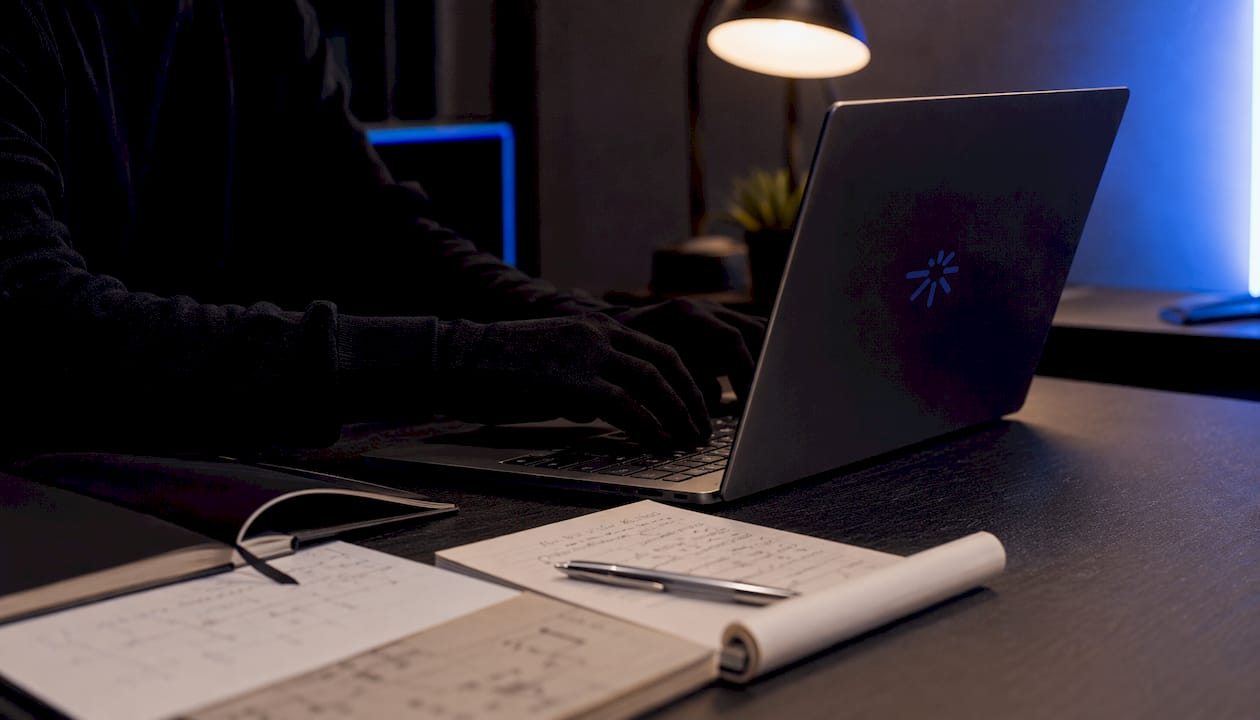 Hands typing code on dark laptop for backtesting