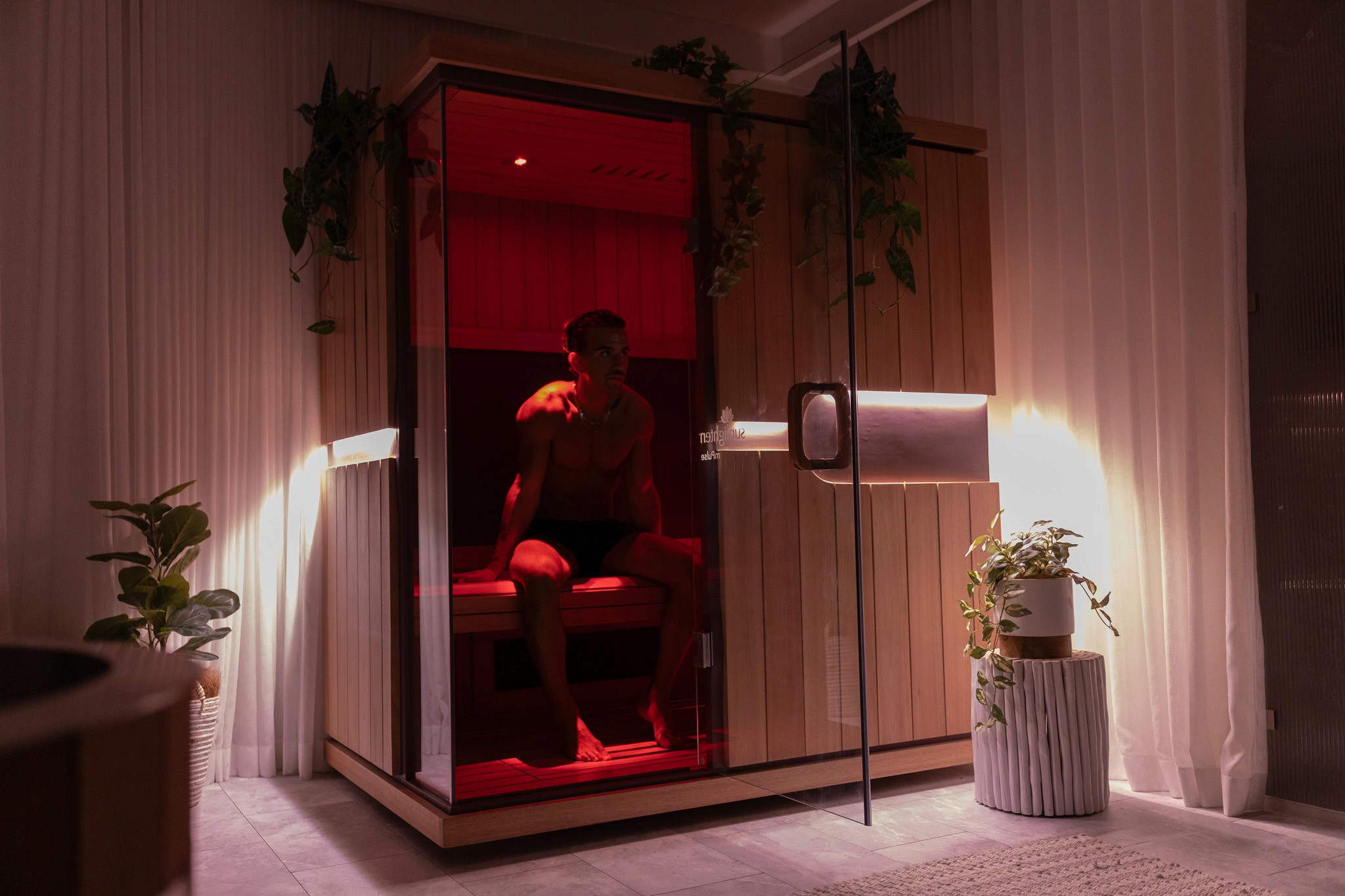 Rachel, personal trainer, looking to the side confidently in a fitness studio