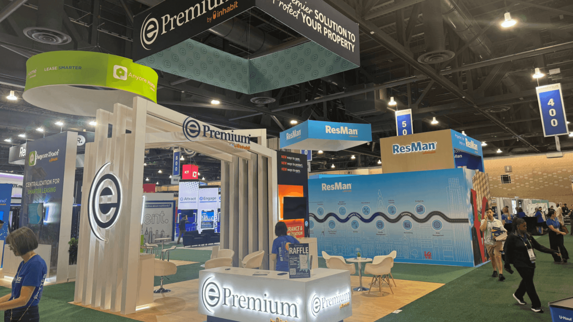 Epremium NAA 2024 20x20 professional service booth with overhead brand identifier, illuminated logo wall, vertical frame structure, and open meeting area
