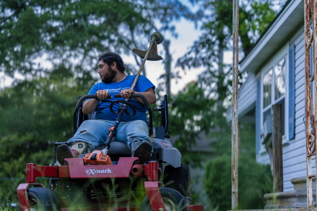 A woman leaning up against a wall of blue lights
