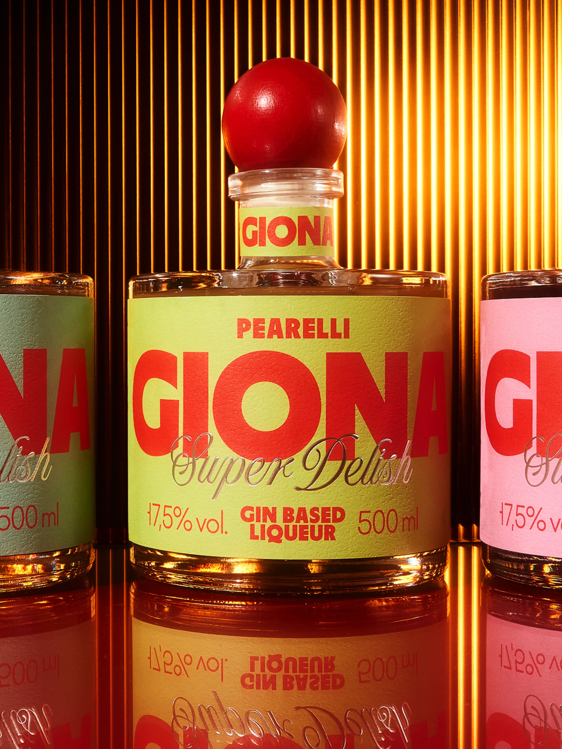 Giona Pearelli bottle centred between Tropicale and Cherrino against golden ribbed glass, packaging design