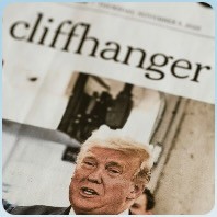 person wearing suit reading business newspaper