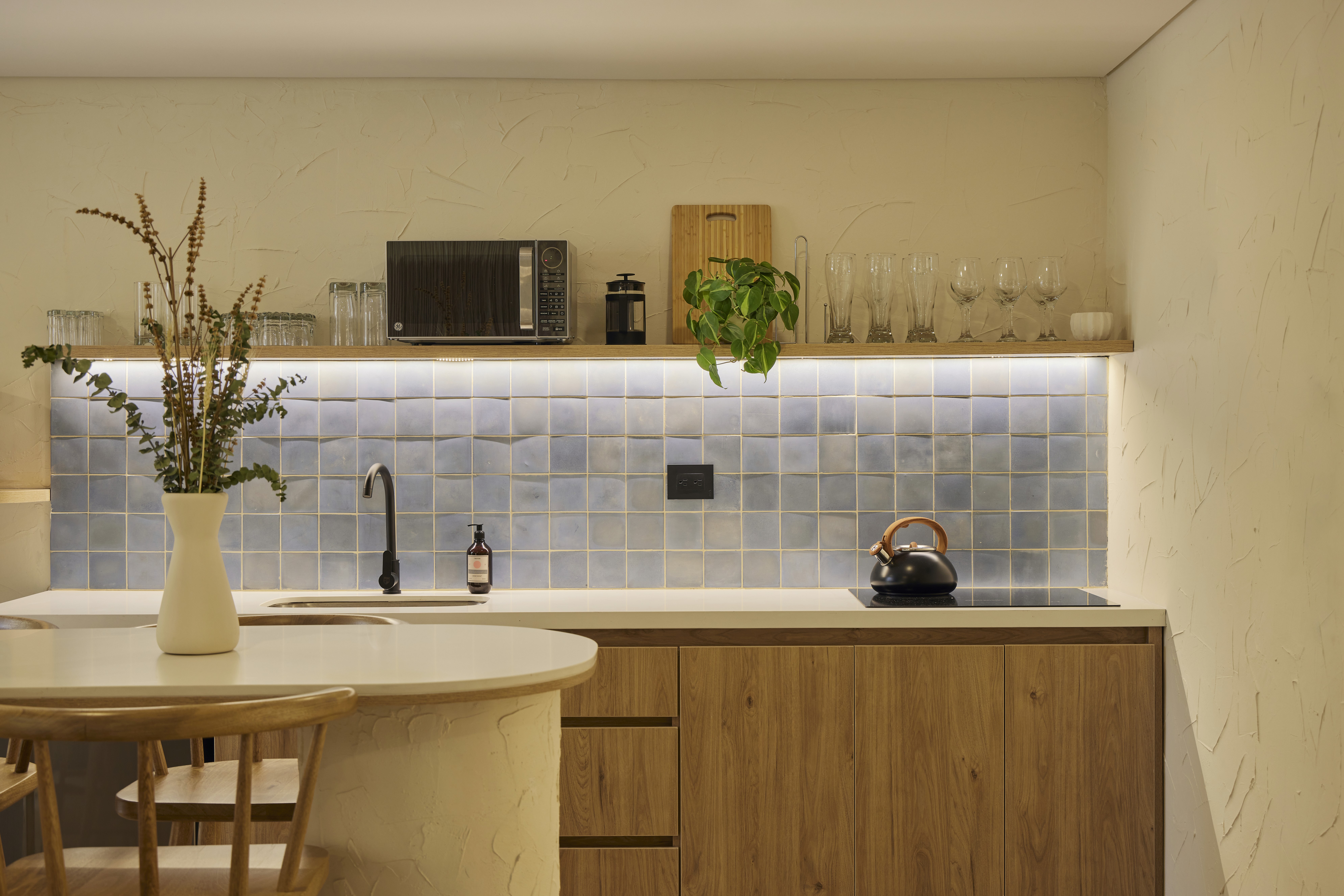 Double-height interior with flowing sculptural forms and warm raking light