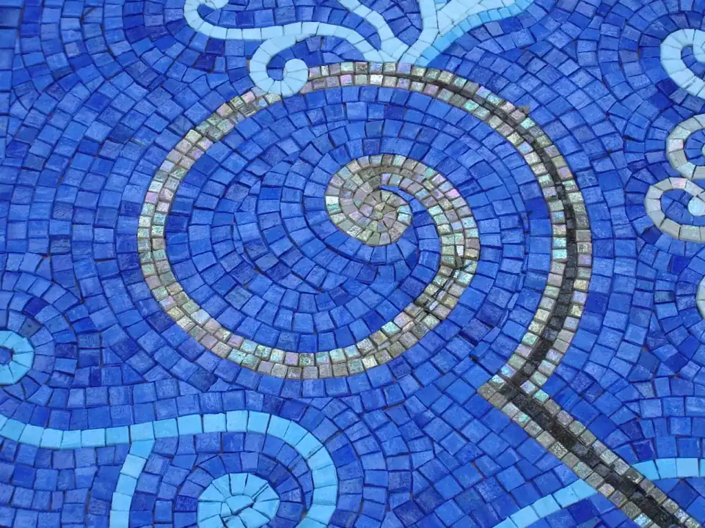 Close detail of the blue glass mosaic, individual tesserae visible — Mosaiclegs Art Studio