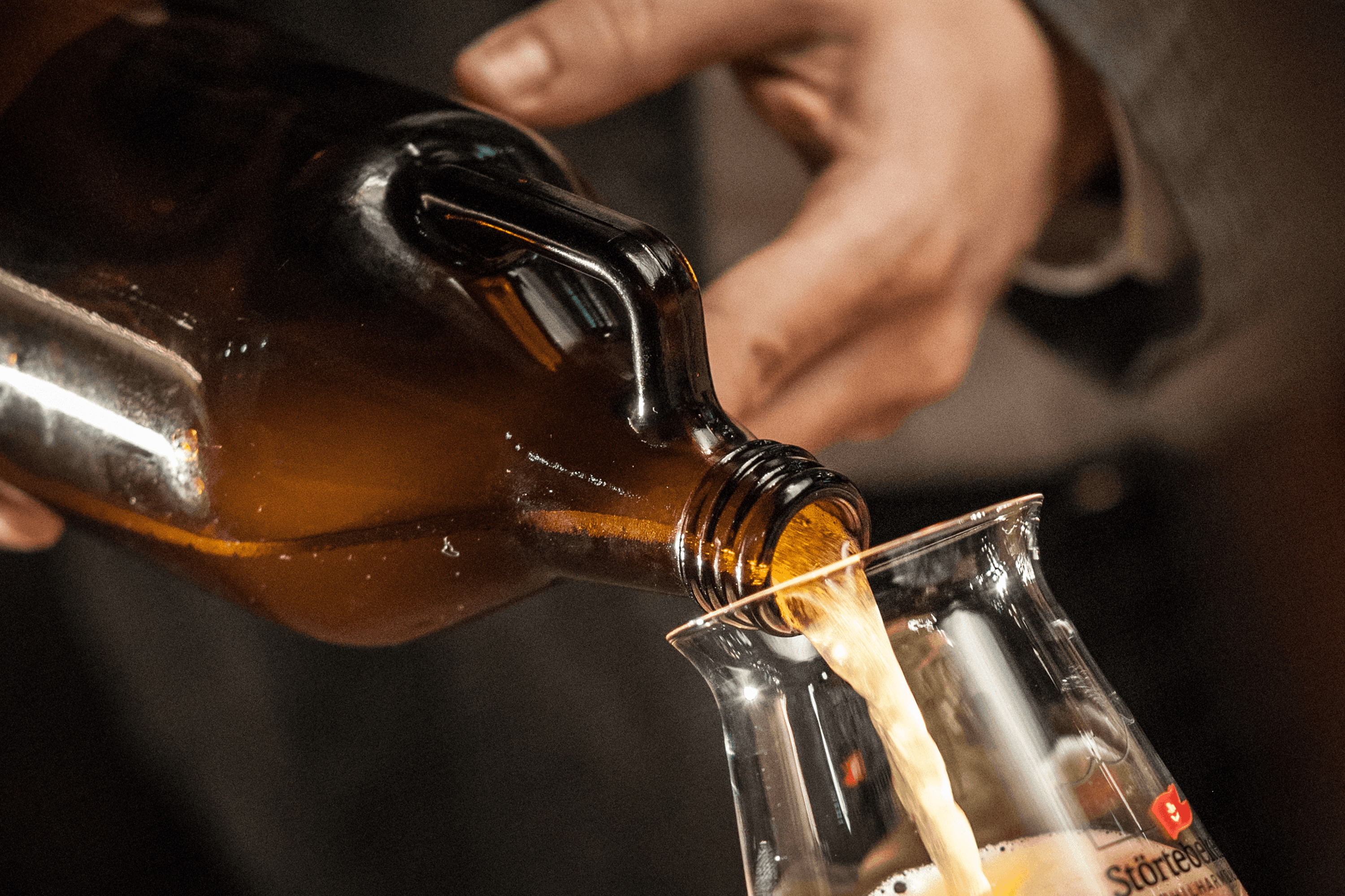 Beer pouring from bottle into glass