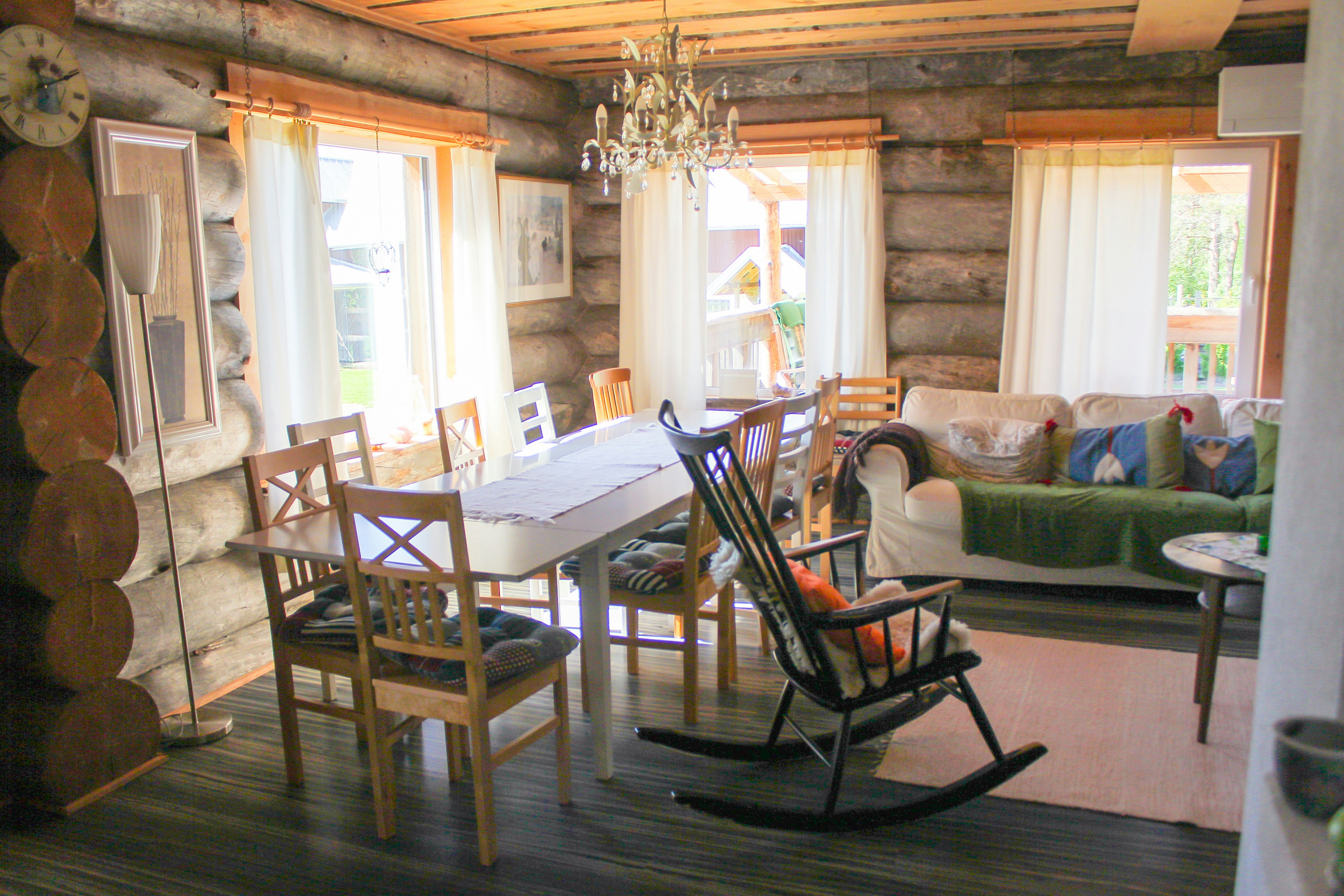 Rustic dining room with a wooden table and rocking chairs.