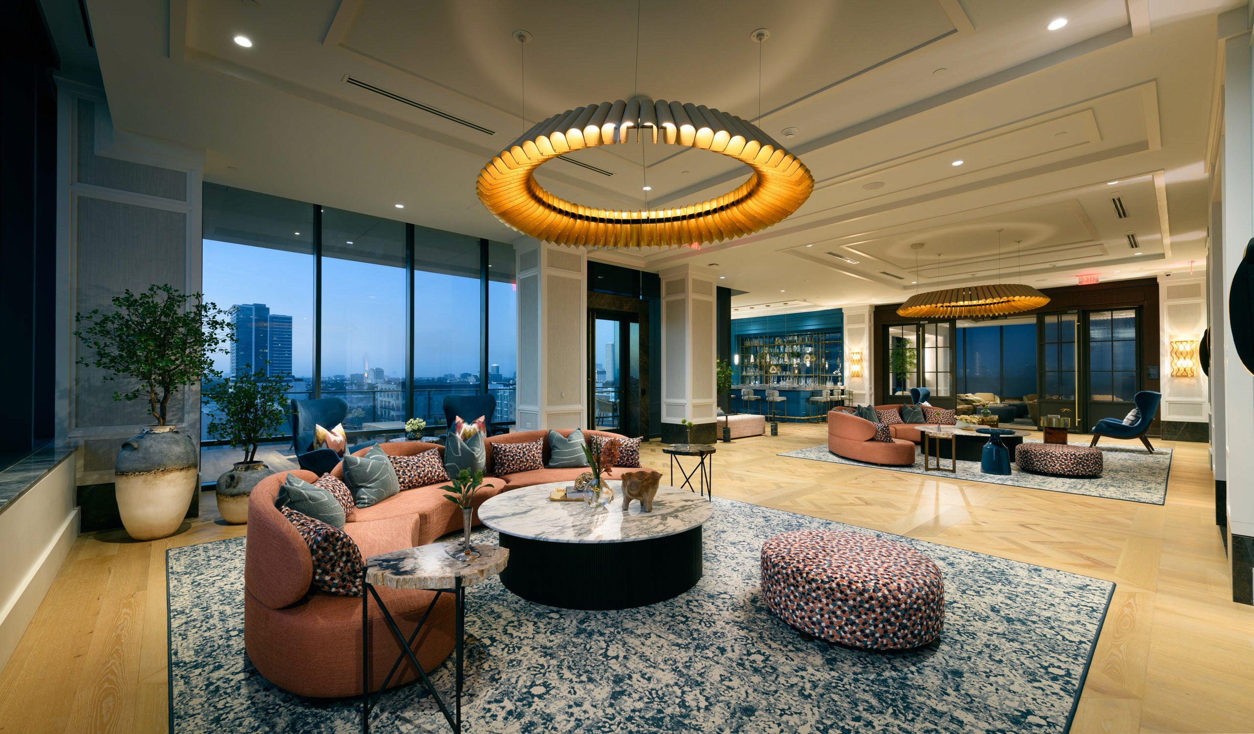 Luxury lounge with large windows and modern furniture.