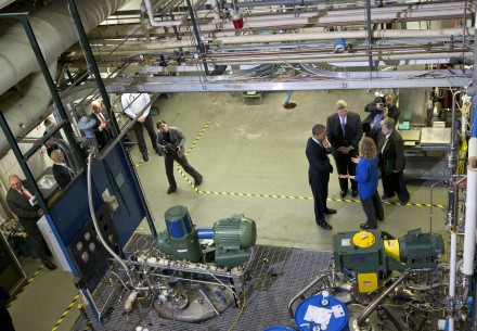 Michigan Biotechnology Institute (MBI) running Verdezyne’s DDDA fermentation. President Barack Obama, center, and Agriculture Secretary Tom Vilsack, second from left, listen during a tour of MBI in Lansing, Mich., Friday, Feb. 7, 2014.