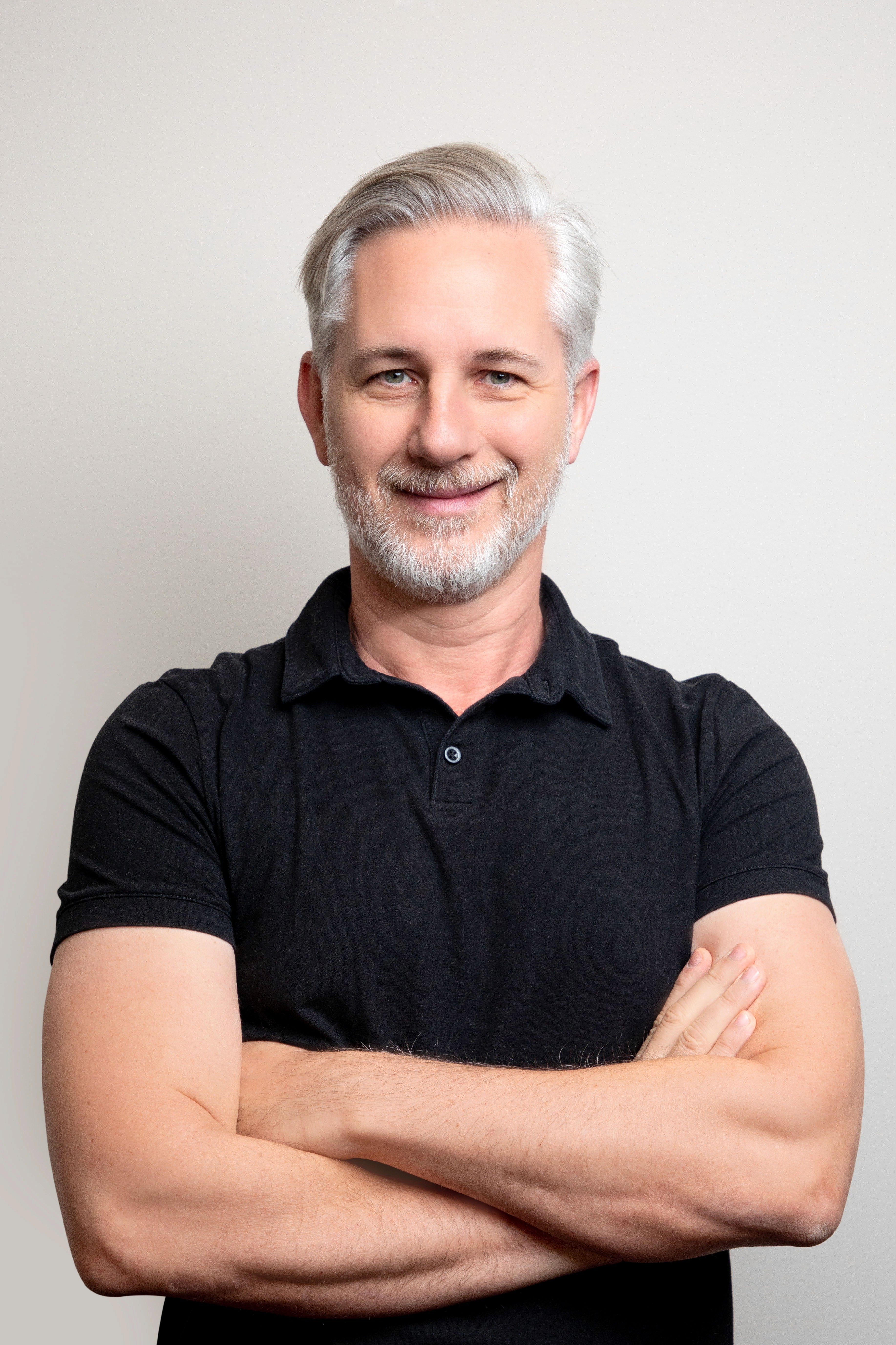image of man wearing glasses folding his arms