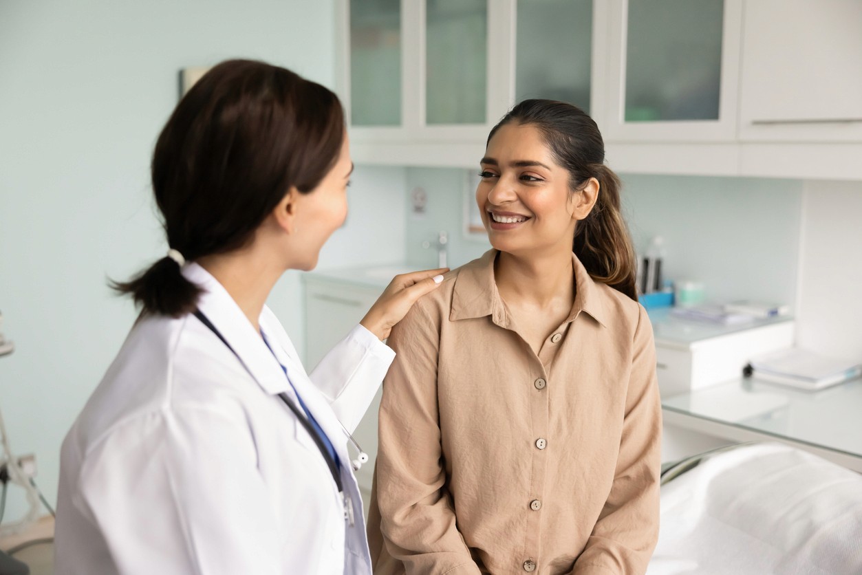 A middle aged women sits with a female doctor while undergoing a Life First comprehensive health assessment