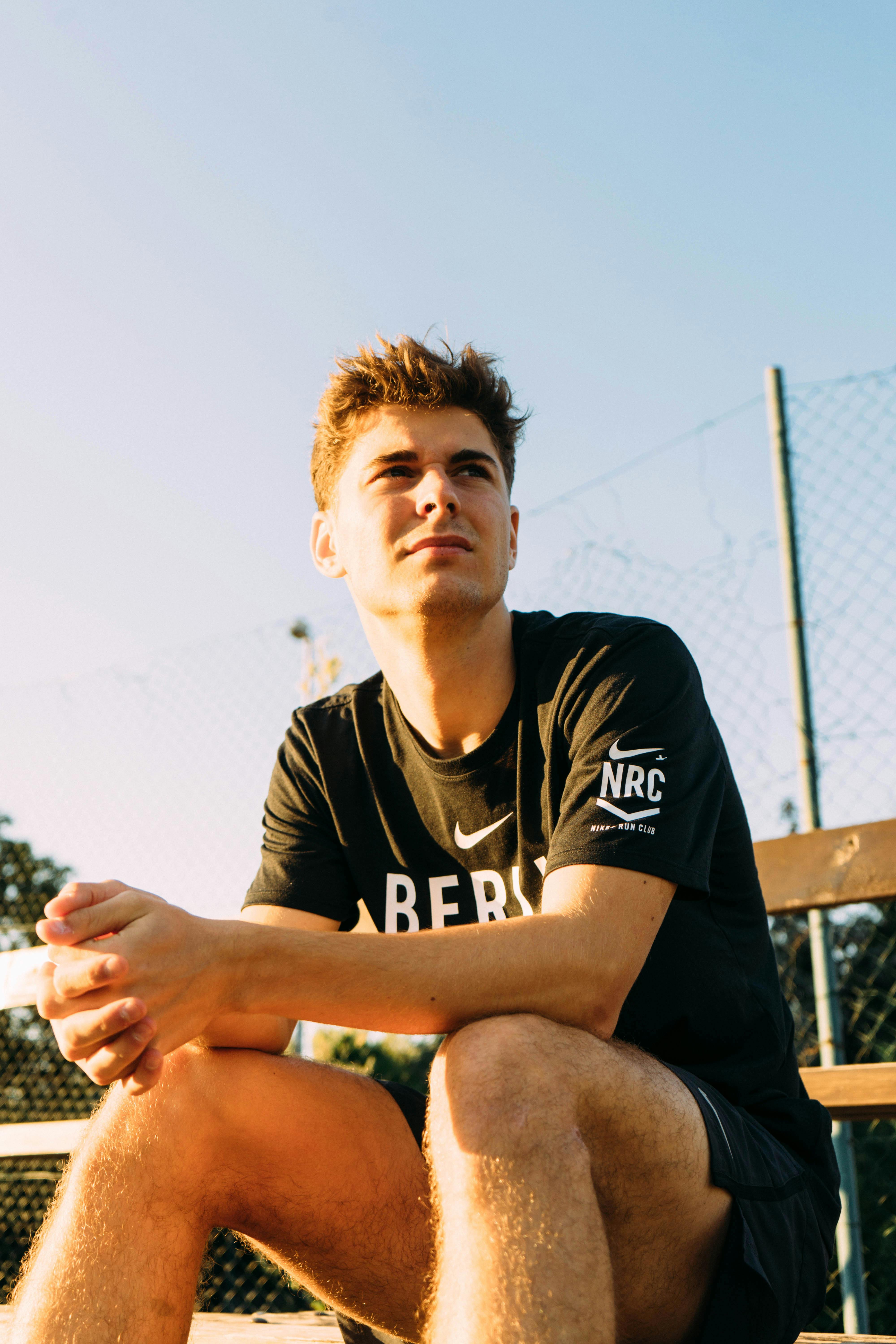 Young person sitting outdoors in casual pose