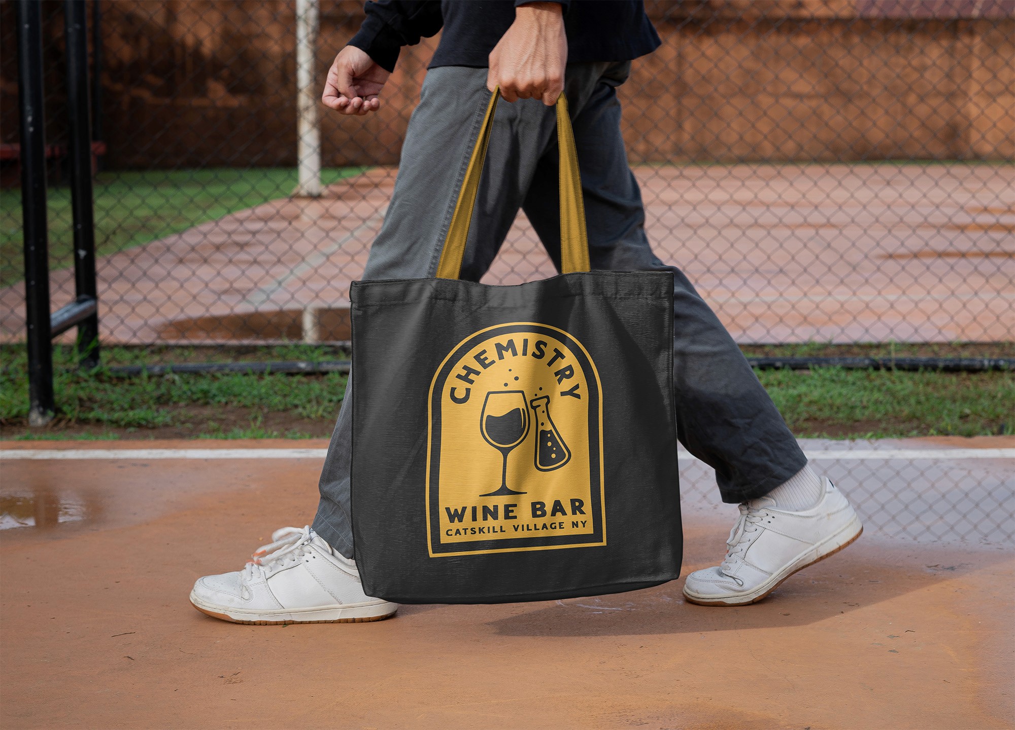 Graphic design mockup of tote bag for Chemistry Wine Bar — bold, badge style logo with decorative sans serif typography, designed by Will Lefkovich.