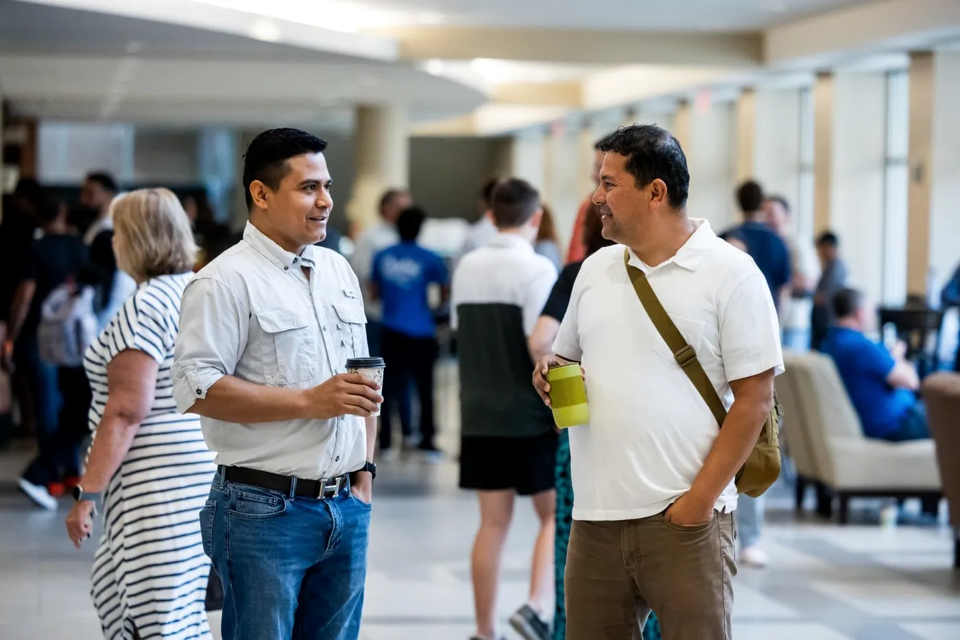 Two men talking in the lobby before a service