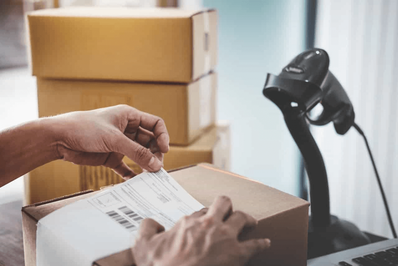 E-commerce worker putting return label on a shipment