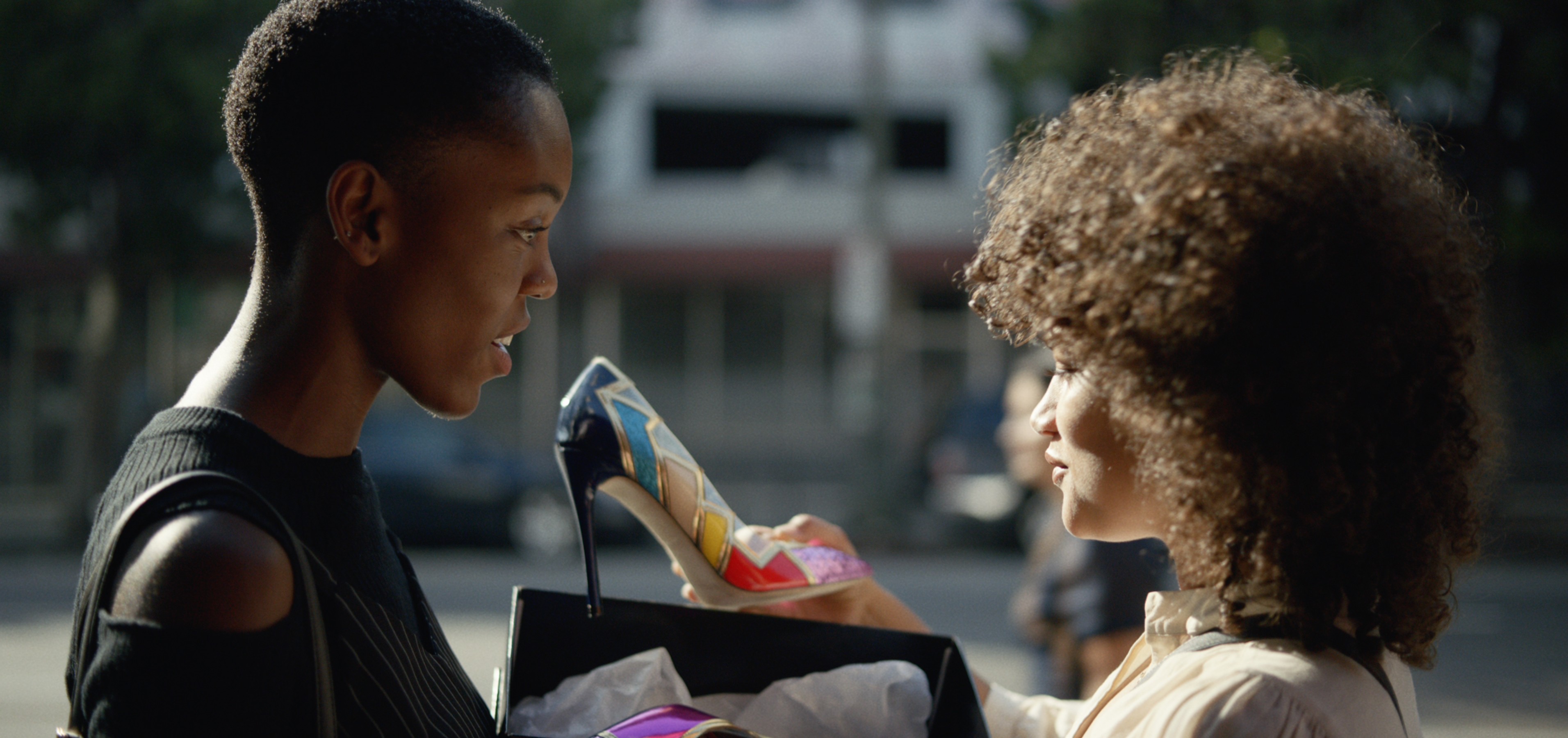 Woman selling a stylish shoe to another woman