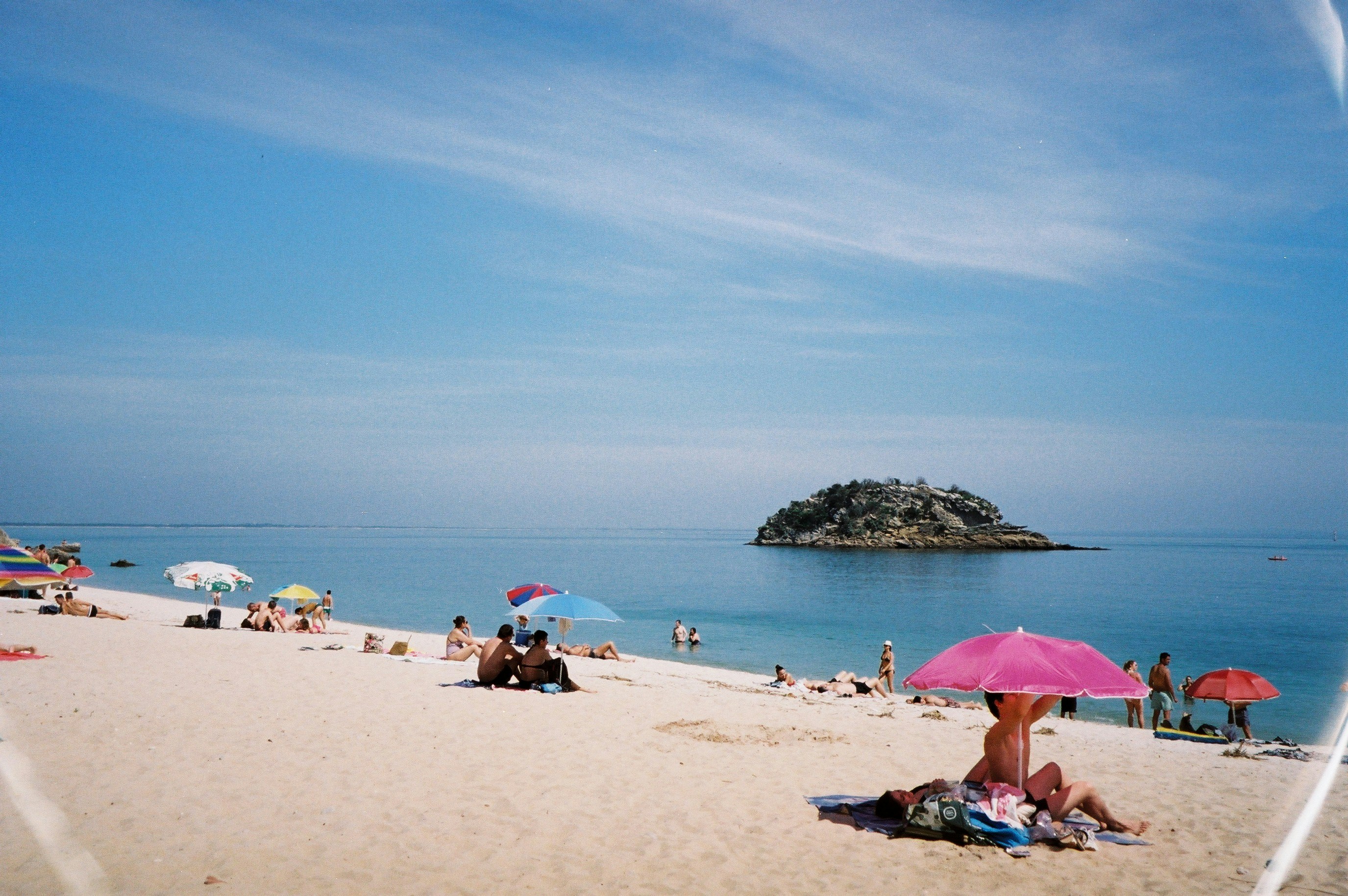 Beach in the Arrabida area near Setubal with people on the sand and blue water