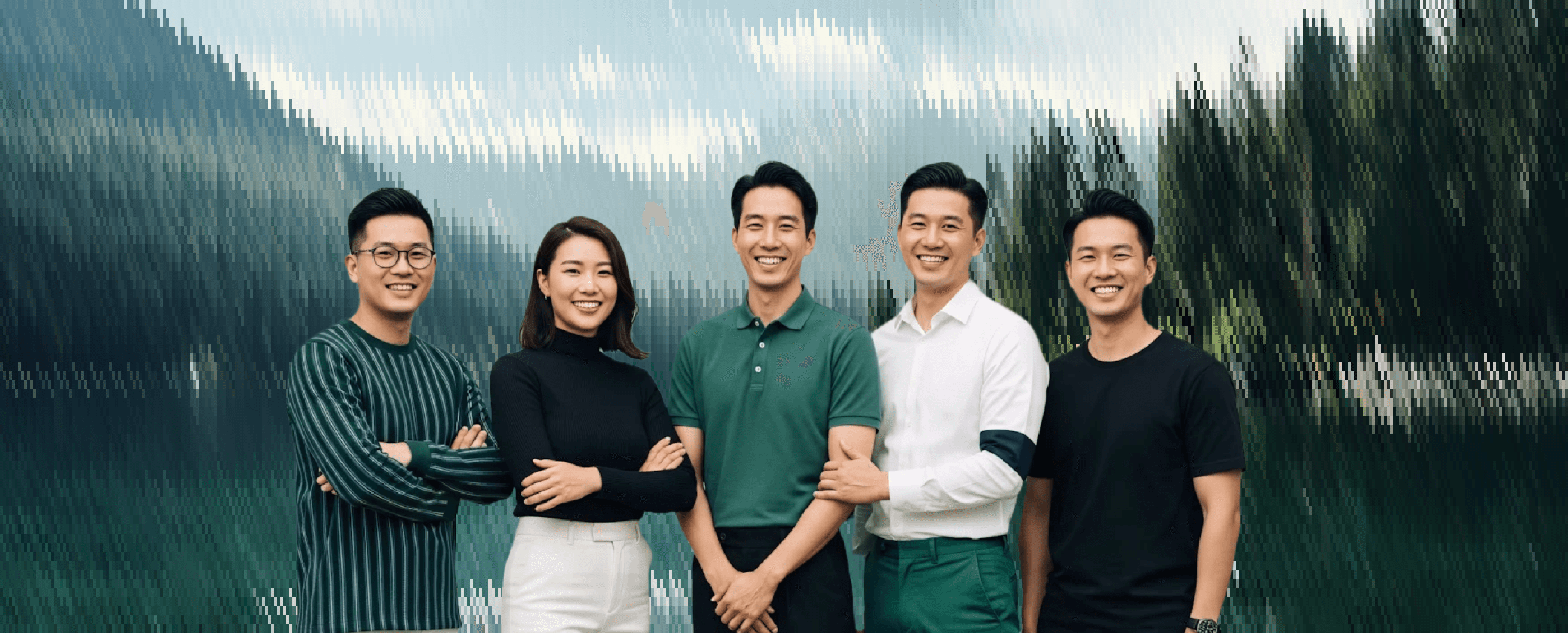 Group portrait of a team standing together, smiling and posing in front of a scenic outdoor background.