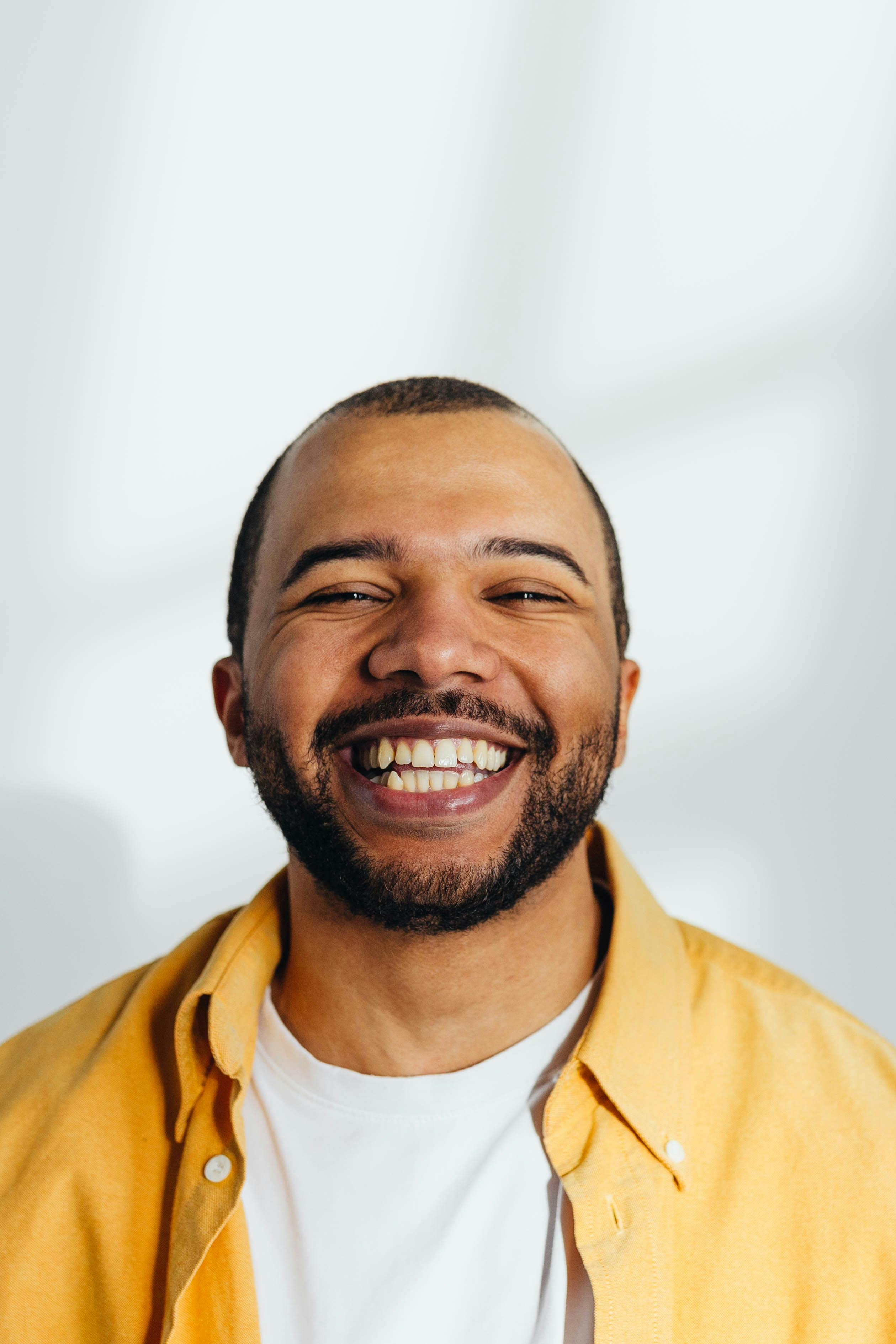 smiling man standing near building